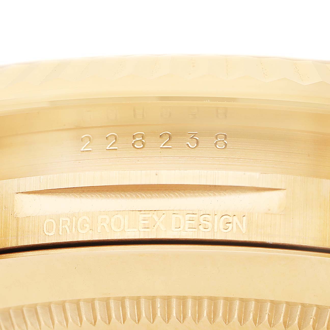The image shows the side of a Rolex President 228238 Men's Yellow Gold Silver Dial watch, highlighting the engraved model number and "Orig. Rolex Design."