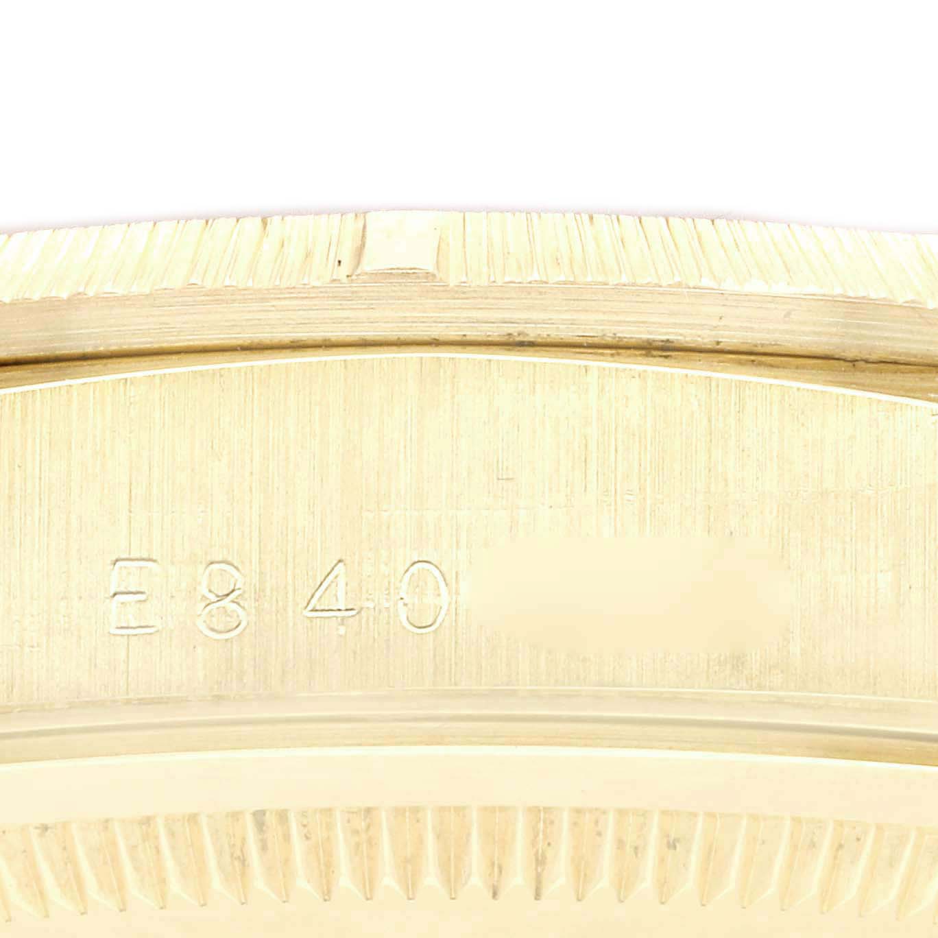 This is a close-up view of the Rolex President 18248 Men
s Yellow Gold Champagne Dial 18248 Men
s Yellow Gold Champagne Dial model, showing part of the case with engraved serial numbers.