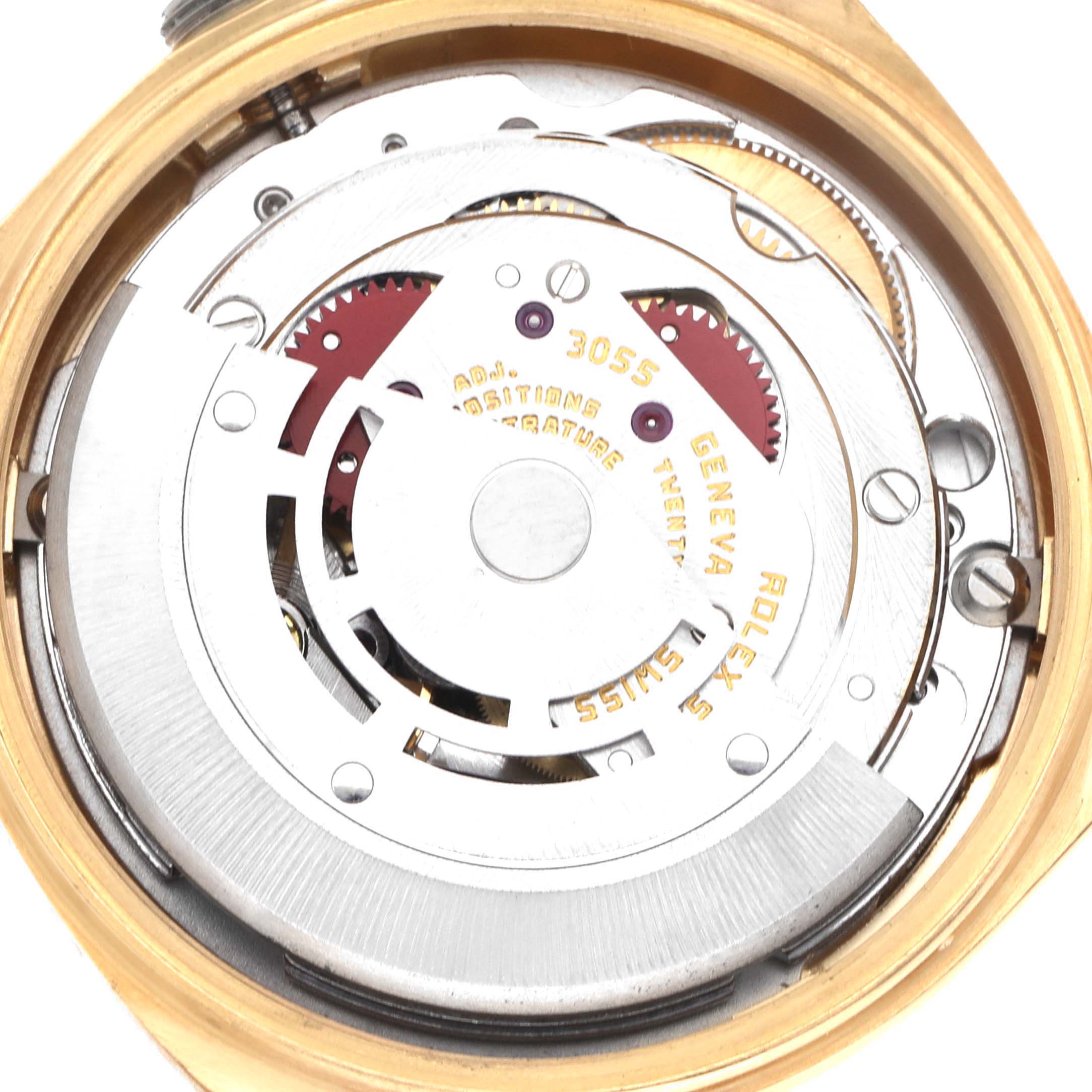The image shows the movement of a Rolex President 18038 Men
s Yellow Gold Champagne Dial 18038 Men
s Yellow Gold Champagne Dial model from a top-down angle, highlighting gears and engravings.