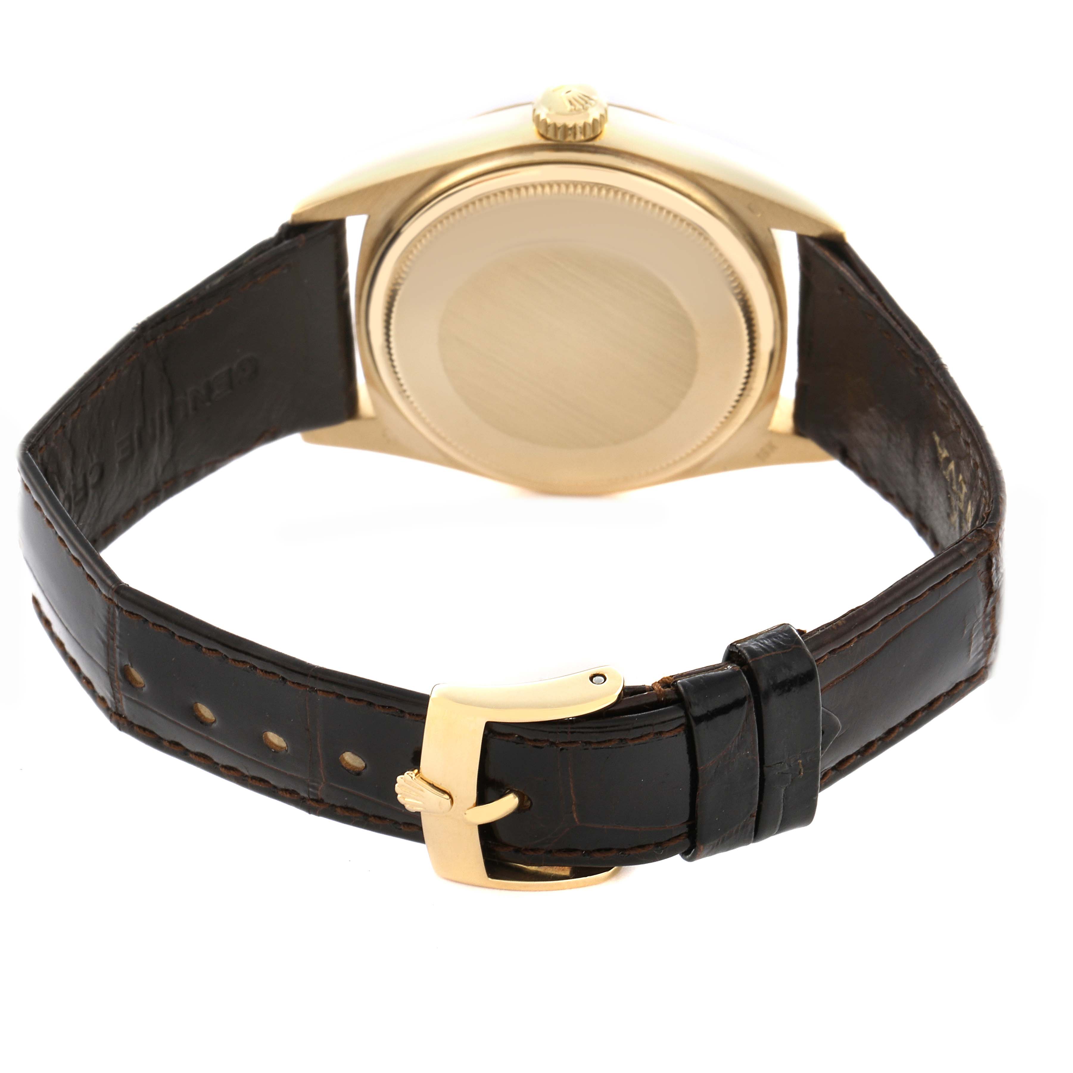 The Rolex President 18038 Men
s Yellow Gold Champagne Dial 18038 Men
s Yellow Gold Champagne Dial model watch is shown from the back, displaying its case and brown leather strap with a gold buckle.