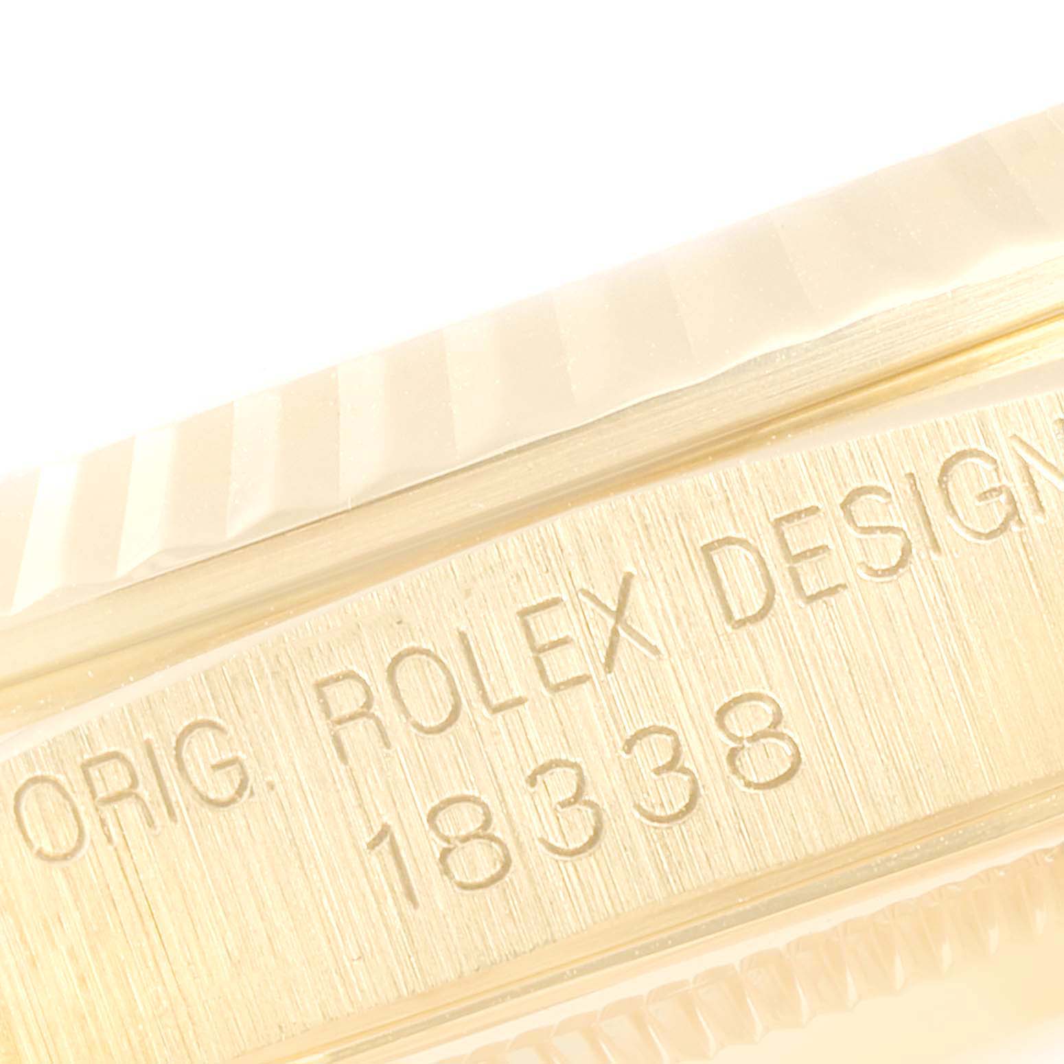 This close-up image shows the side engraving and part of the bezel of the Rolex President 18338 Men
s Yellow Gold Champagne Dial 18338 Men
s Yellow Gold Champagne Dial model 18338.