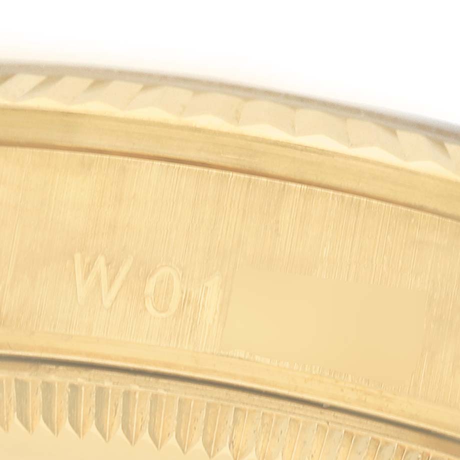 The image shows a close-up of the Rolex Datejust 68238 Women's Yellow Gold Champagne Dial bezel and case, highlighting the engravings.