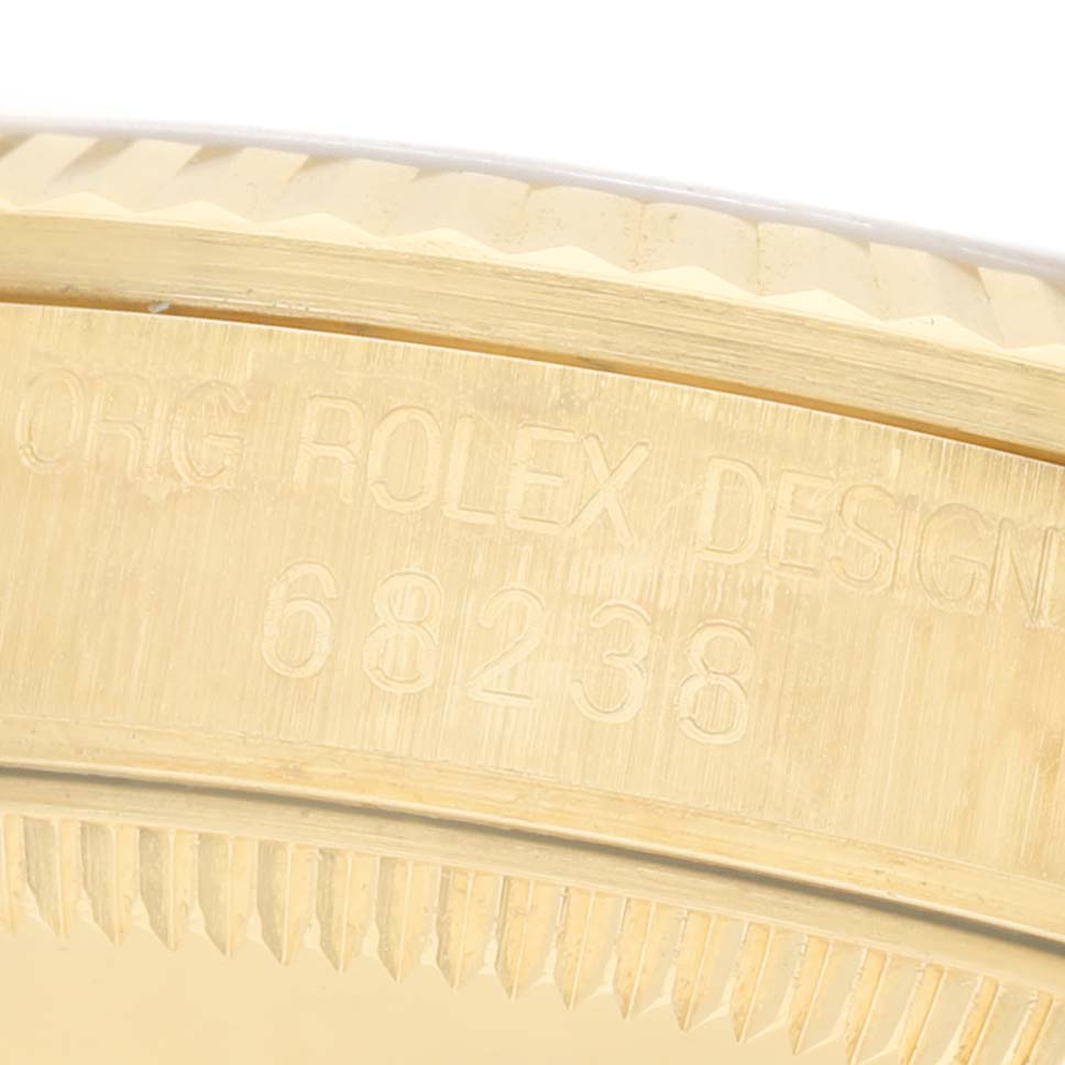 The image shows a close-up of the side casing of a Rolex Datejust 68238 Women's Yellow Gold Champagne Dial watch, focusing on the engraved model number.