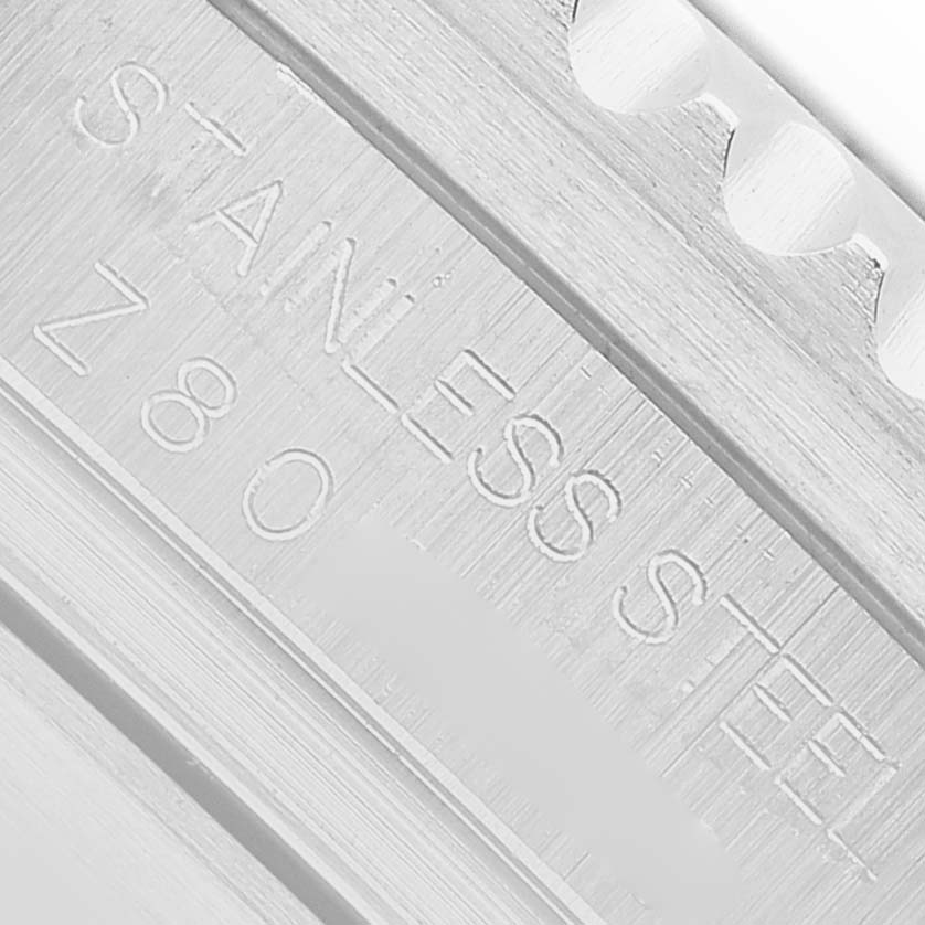 The image shows a close-up of the stainless steel marked surface of the Rolex Sea-Dweller 16600 Men's Stainless Steel Black Dial watch, focusing on the bezel edge.
