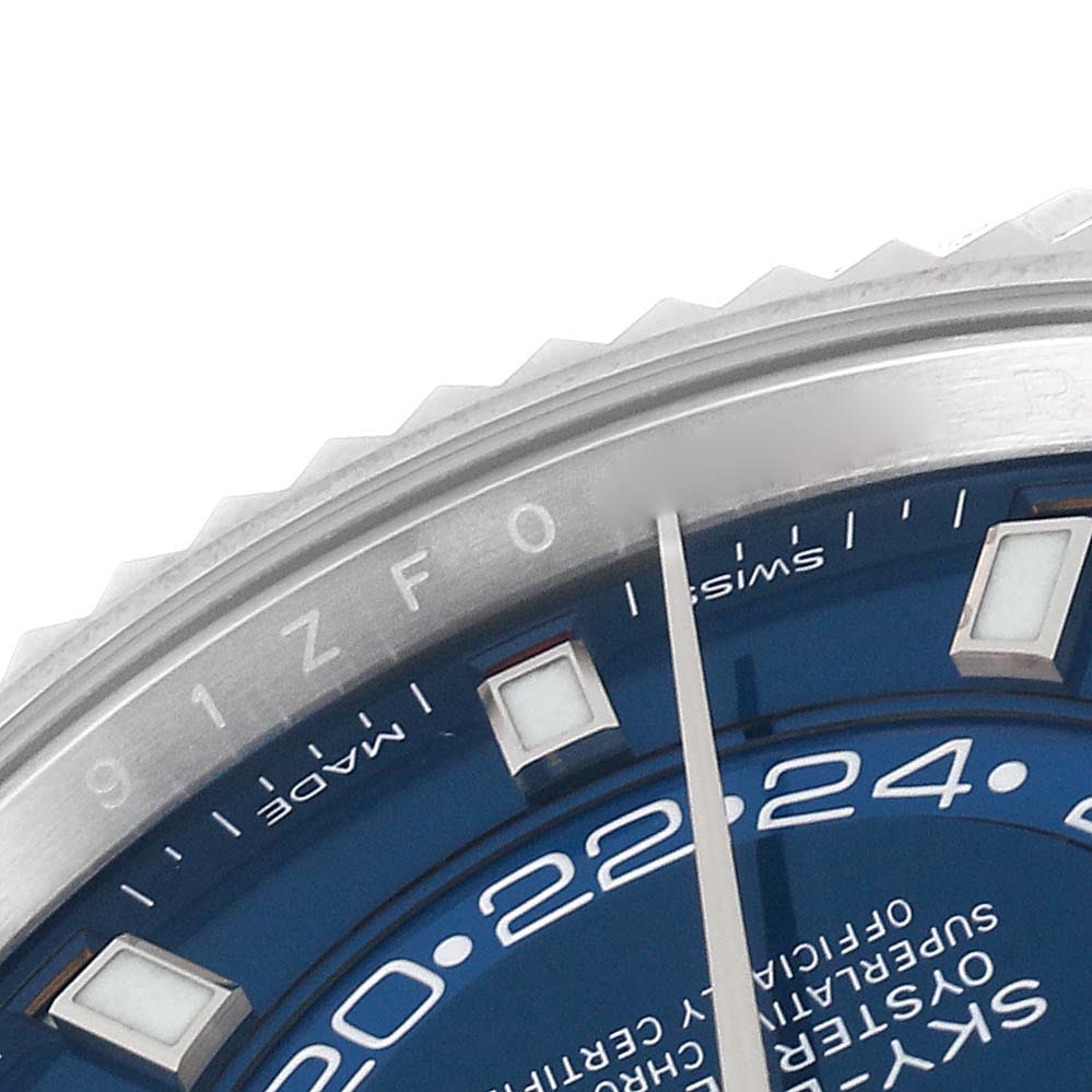 The image shows the upper-left section of the blue dial and fluted bezel of a Rolex Sky-Dweller 326934 Men's Stainless Steel Blue Dial 326934 Men's Stainless Steel Blue Dial watch.