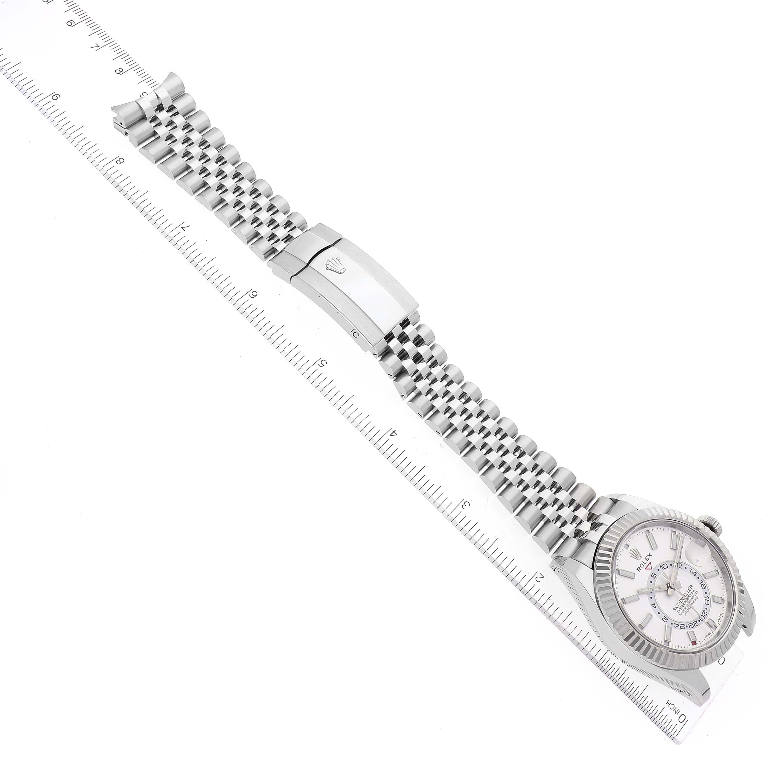 The image shows a Rolex Sky-Dweller 326934 Men's Stainless Steel White Dial 326934 Men's Stainless Steel White Dial watch laid flat, showcasing its face, bezel, bracelet, and clasp from an overhead angle.