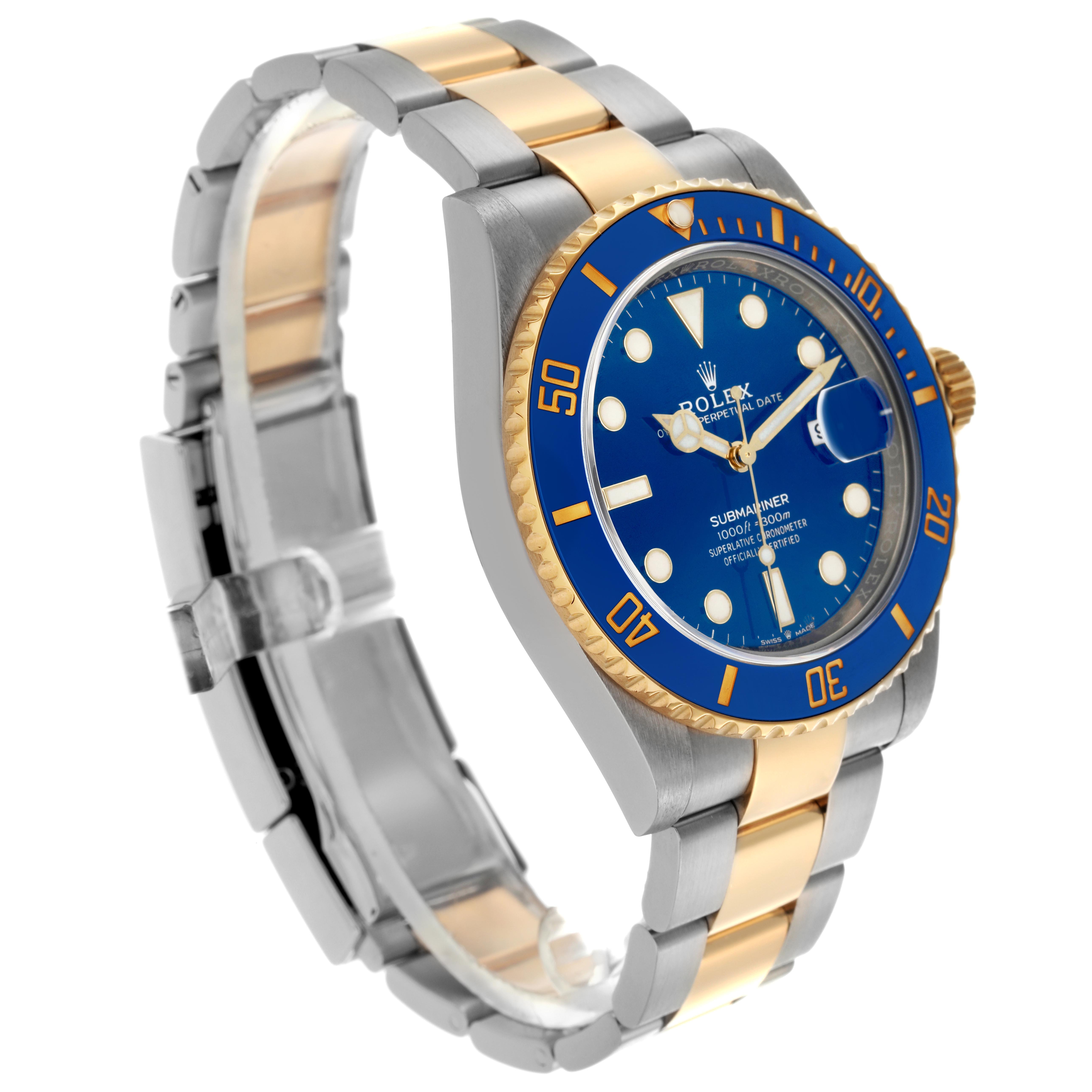 The image shows a three-quarter view of a Rolex Submariner 126613 Men
s Steel and Gold (two tone) Blue Dial 126613 Men
s Steel and Gold (two tone) Blue Dial, highlighting its gold and silver bracelet and blue bezel.