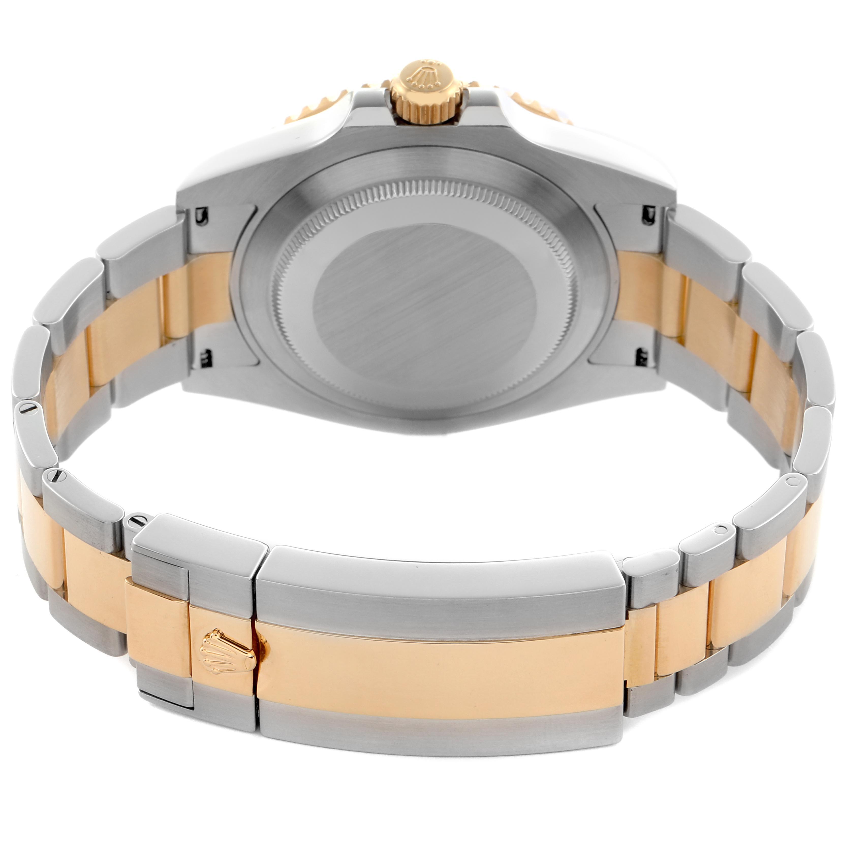 The image shows the back of a Rolex Submariner 126613 Men
s Steel and Gold (two tone) Blue Dial 126613 Men
s Steel and Gold (two tone) Blue Dial watch, highlighting its case, crown, and two-tone bracelet.