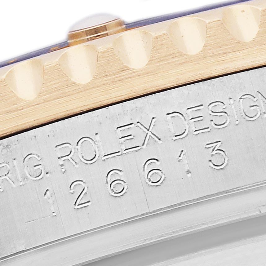 The image shows a close-up of the side of the Rolex Submariner 126613 Men
s Steel and Gold (two tone) Blue Dial 126613 Men
s Steel and Gold (two tone) Blue Dial, highlighting the engraved design number.