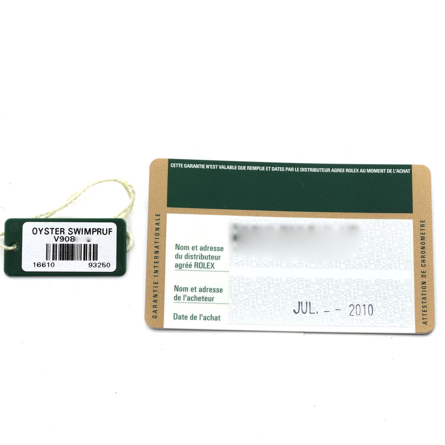 The image shows a warranty card and a tag for a Rolex Submariner 16610 Men's Stainless Steel Black Dial 16610 Men's Stainless Steel Black Dial, model 16610, dated July 2010.