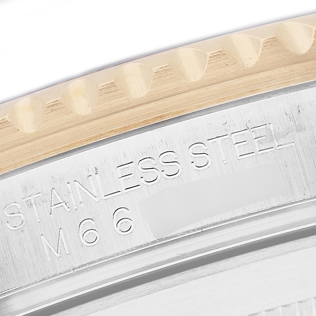The image shows a close-up of the case back edge and part of the bezel, with "STAINLESS STEEL" engraved on the Rolex Submariner 16613 Men
s Steel and Gold (two tone) Blue Dial 16613 Men
s Steel and Gold (two tone) Blue Dial.