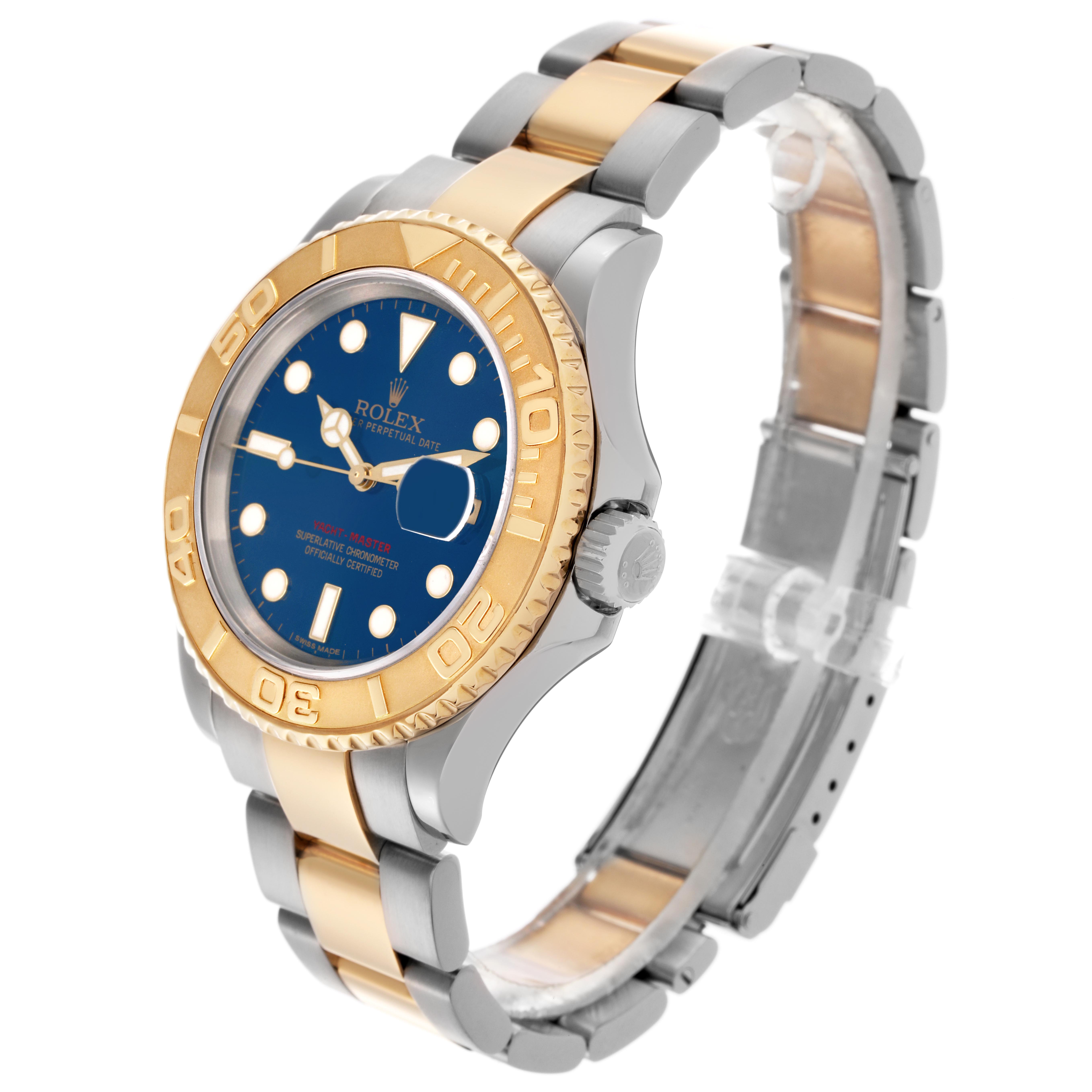 The Rolex Yacht-Master 16623 Men
s Steel and Gold (two tone) Blue Dial 16623 Men
s Steel and Gold (two tone) Blue Dial watch is shown from a front angle, highlighting its bezel, dial, crown, and two-tone bracelet.