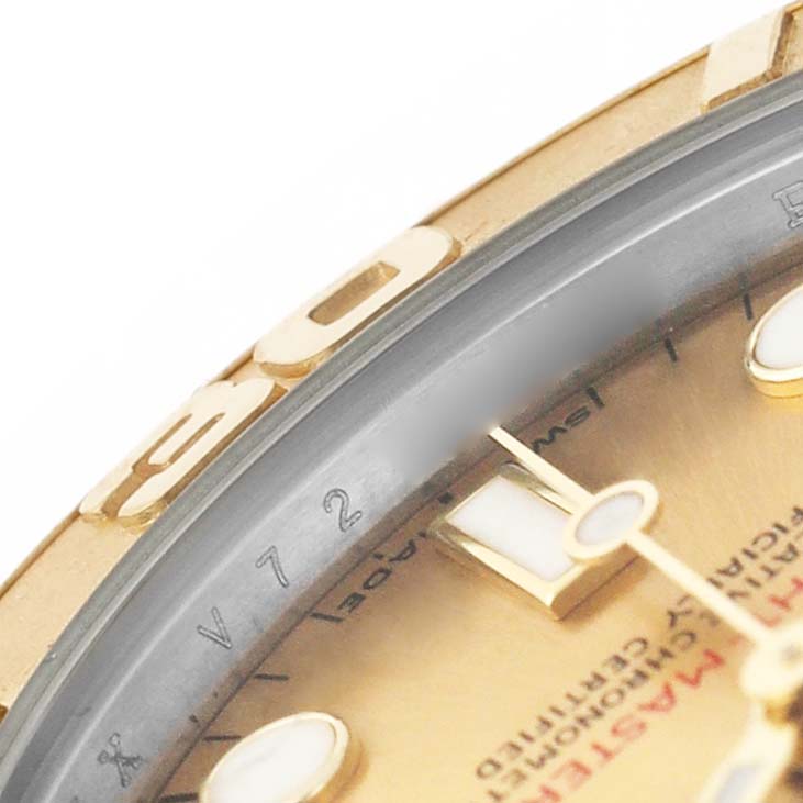 The image shows a close-up of the Rolex Yacht-Master 168623 Men's Steel and Gold (two tone) Champagne Dial's bezel and part of the dial with markers.