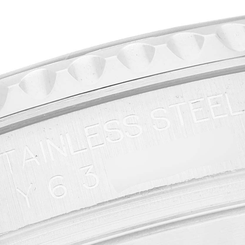 This close-up image shows the serrated edge and part of the engraving on the stainless steel bezel of a Rolex Yacht-Master 16622 Men's Stainless Steel Silver Dial 16622 Men's Stainless Steel Silver Dial watch.