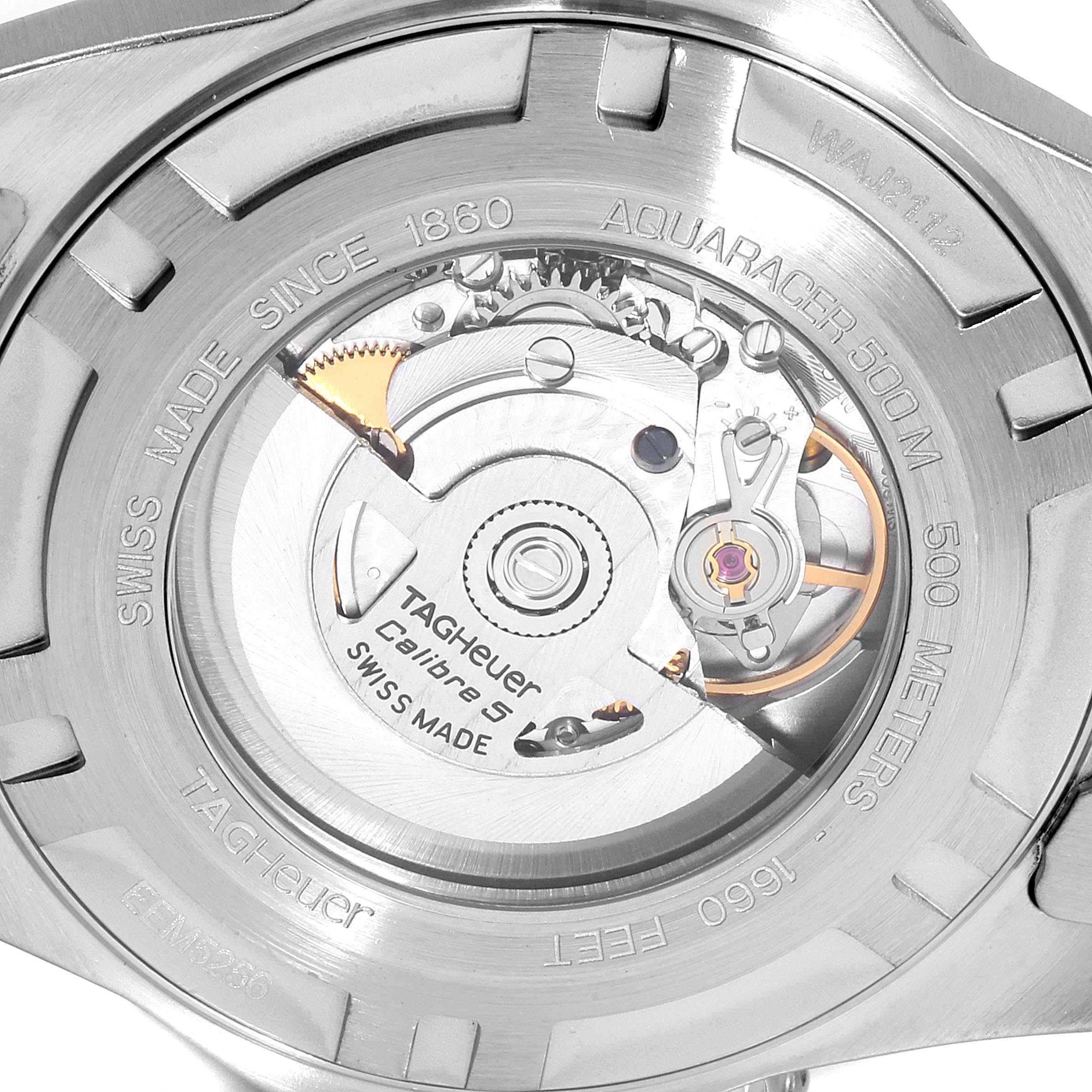 The image shows a close-up of the Tag Heuer Aquaracer WAJ2112 Men's Stainless Steel Blue Dial WAJ2112 Men's Stainless Steel Blue Dial watch case back, revealing the internal Calibre 5 movement.