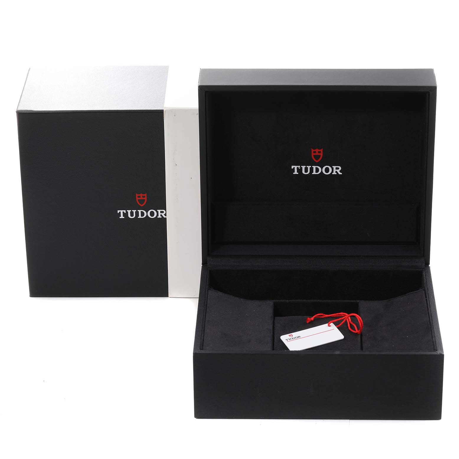 The image shows the open packaging box for the Tudor Heritage Black Bay M79470-0003 Men
s Stainless Steel Black Dial M79470-0003 Men
s Stainless Steel Black Dial watch, including an outer box, inner box, and a tag with a red string.