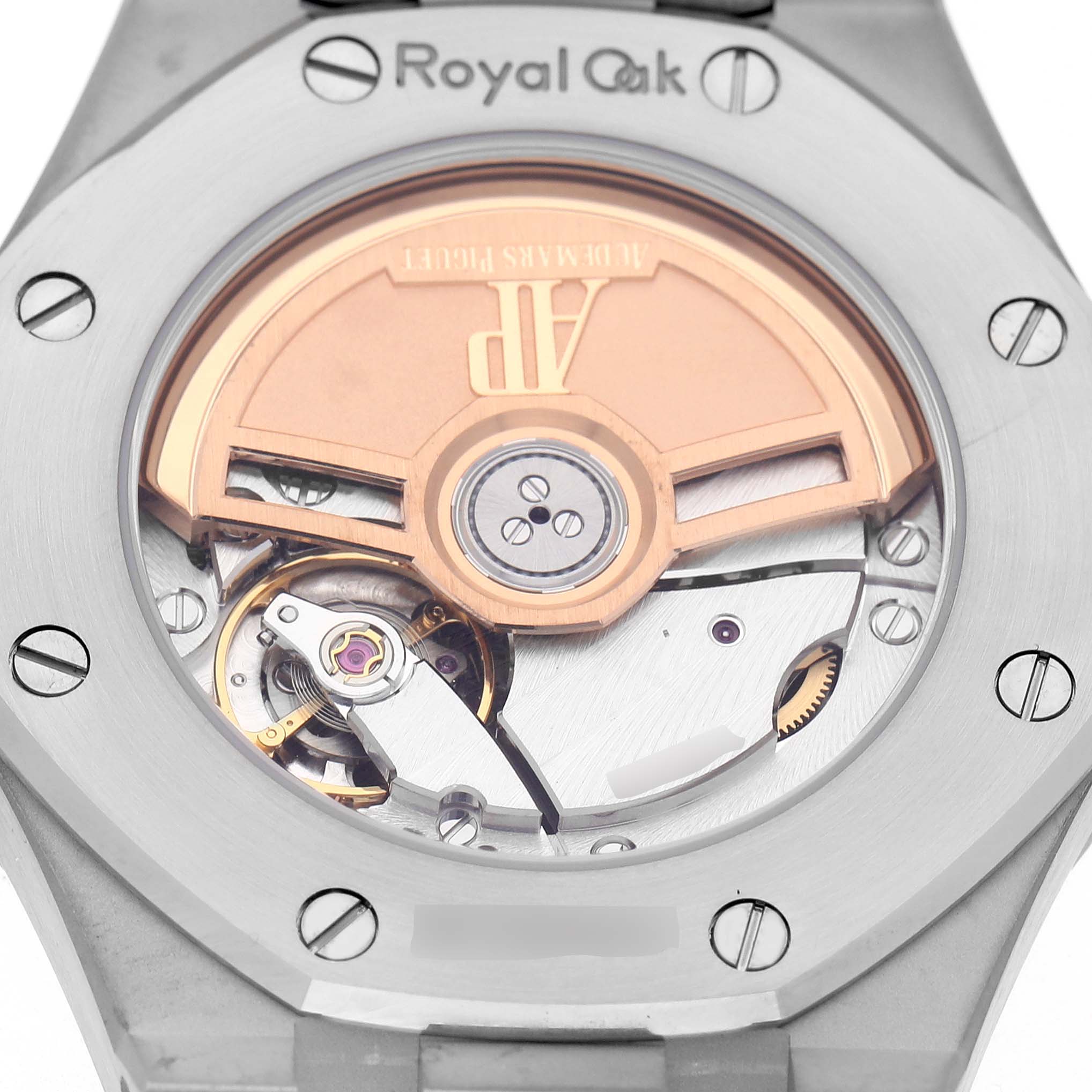 The image shows the back of an Audemars Piguet Royal Oak 77451ST Women's Stainless Steel Blue Dial watch, highlighting its exposed movement and oscillating weight.