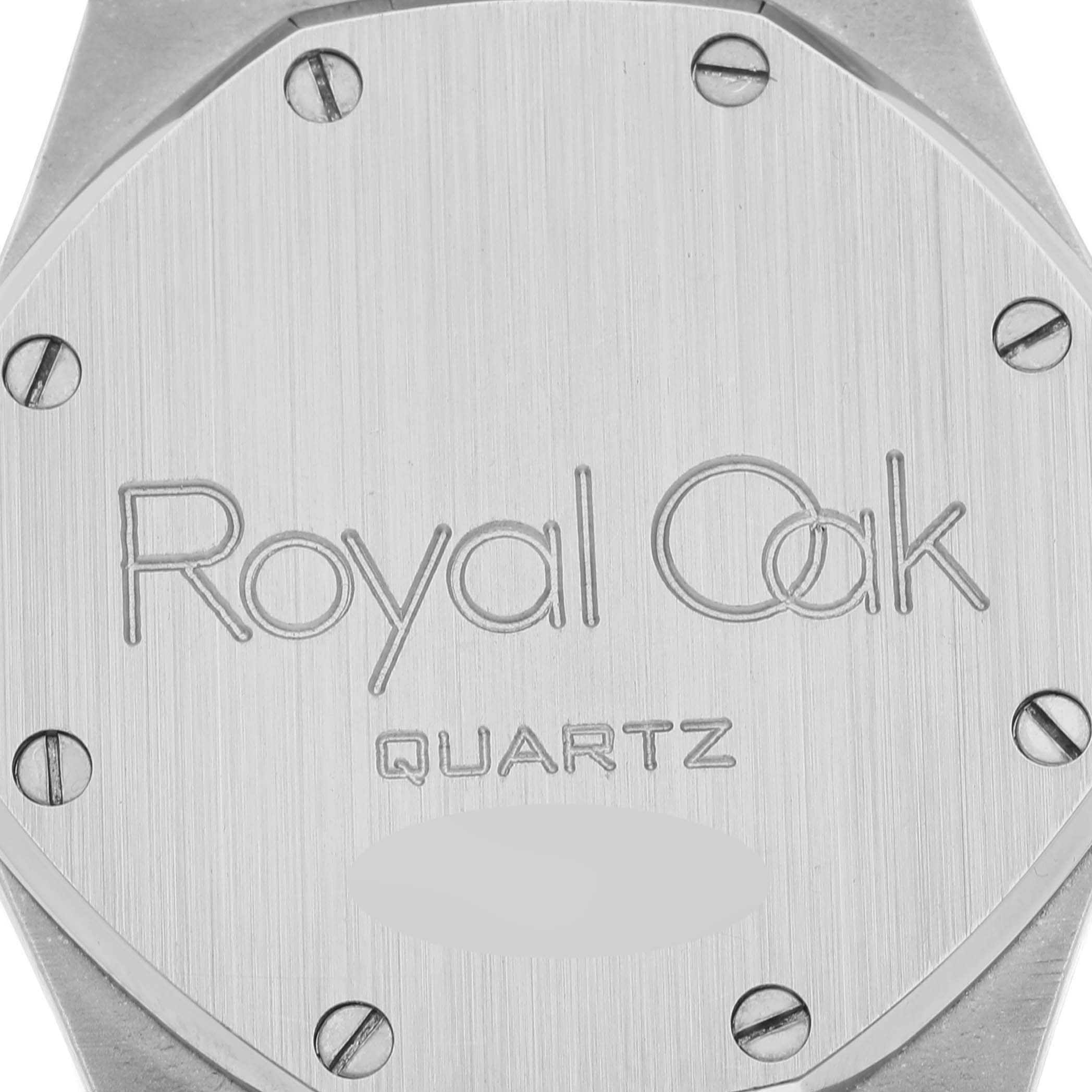 The image shows the back case of a Royal Oak Quartz watch by Audemars Piguet, featuring engraved text and screws.