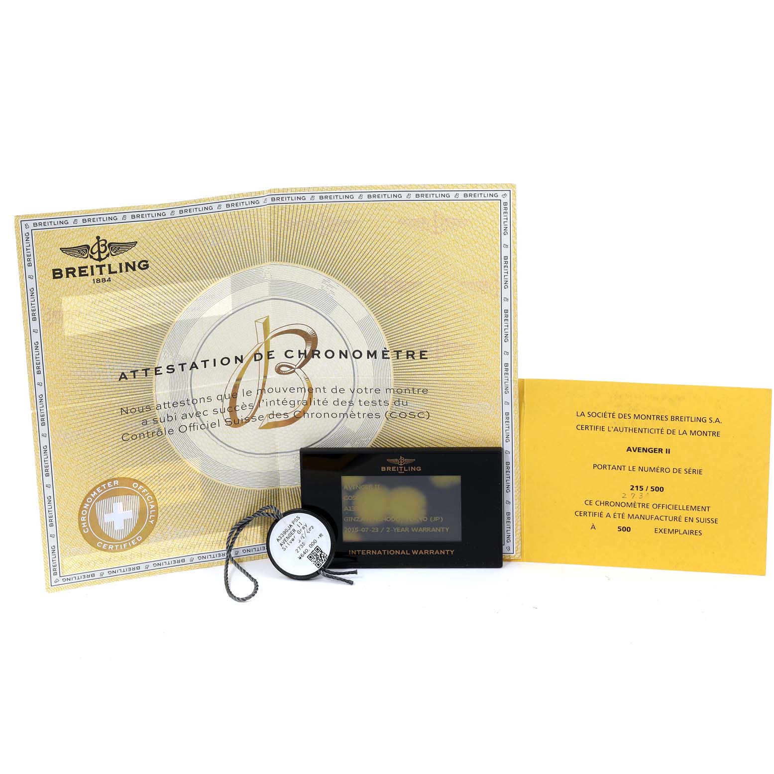 The image shows the Breitling Avenger A13381 Men's Stainless Steel White Dial A13381 Men's Stainless Steel White Dial model's certification documents, warranty card, and a small round tag.