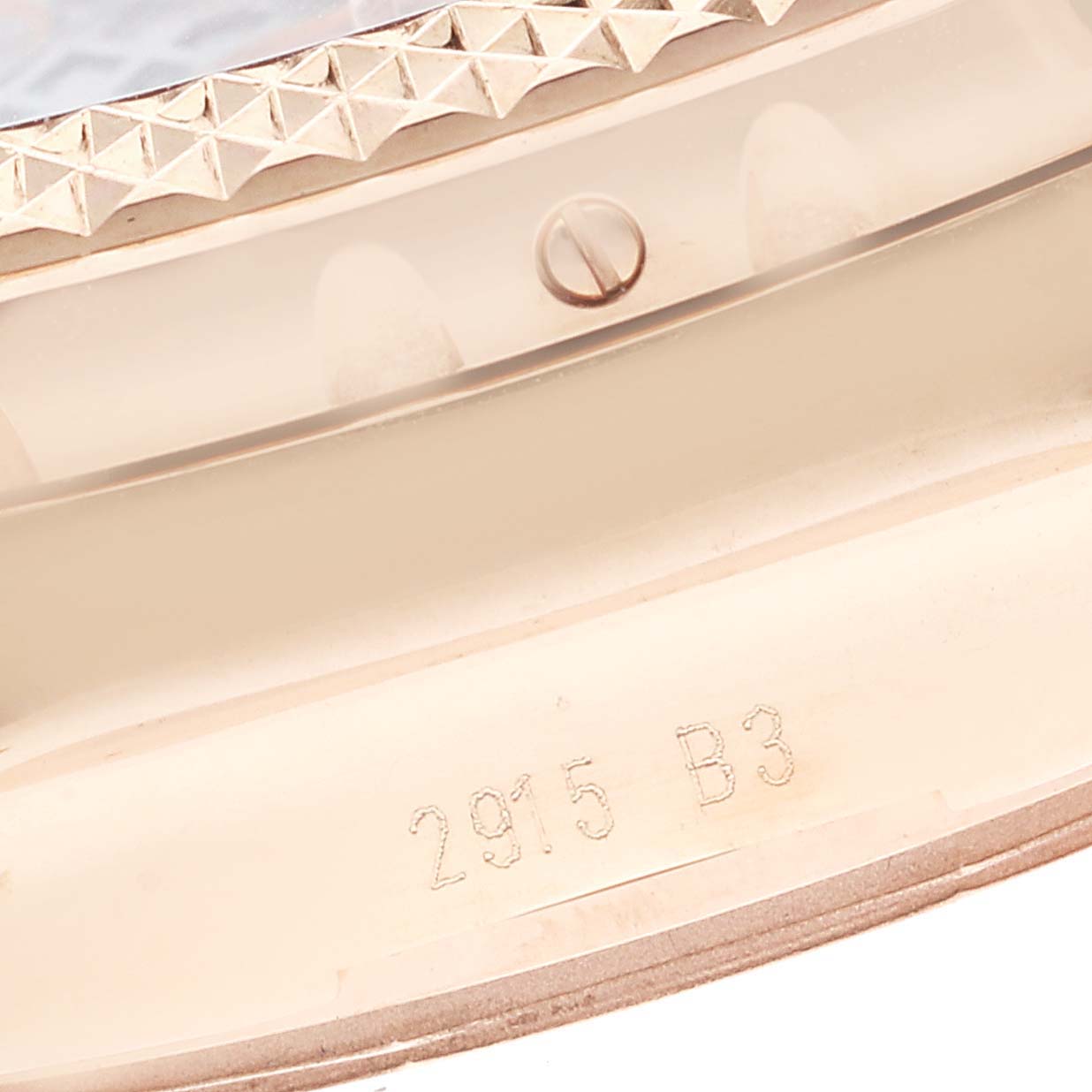 This image shows the side profile of the bezel and case of a Breitling Bentley RB061221/BE24-743P Men's Rose Gold Black Dial RB061221/BE24-743P Men's Rose Gold Black Dial model watch, including a screw and serial number engraving.