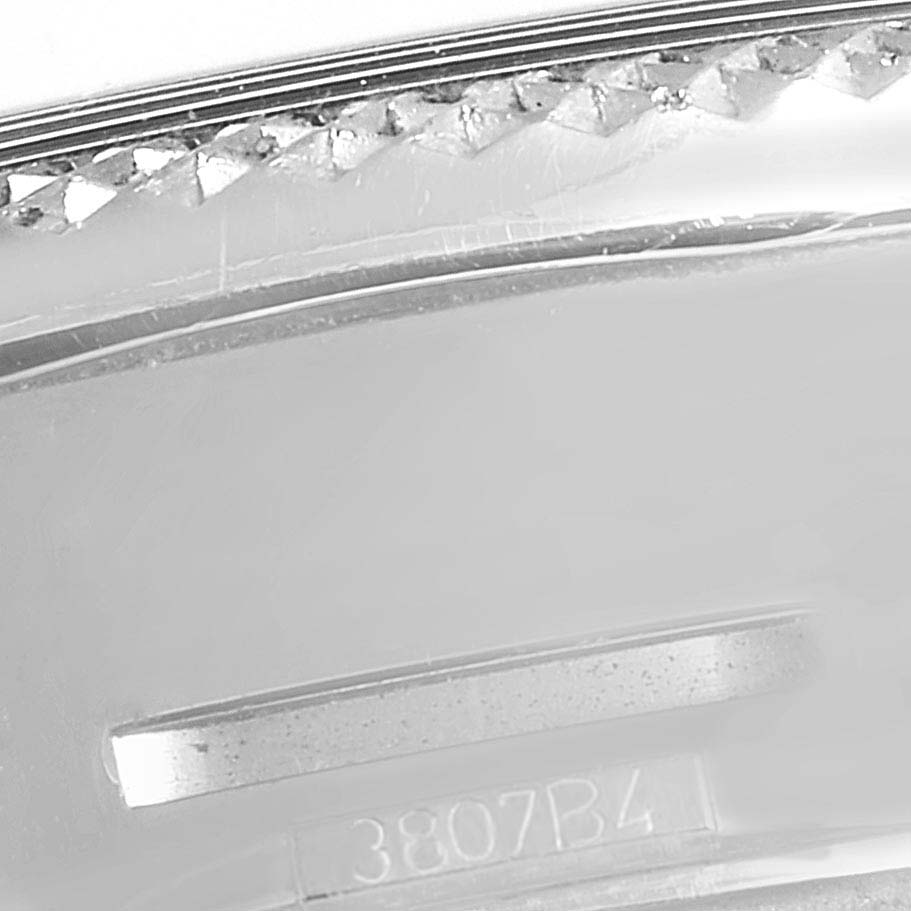 The photo shows a close-up of the bezel and case back of a Bentley model by Breitling, including part of the serial number.