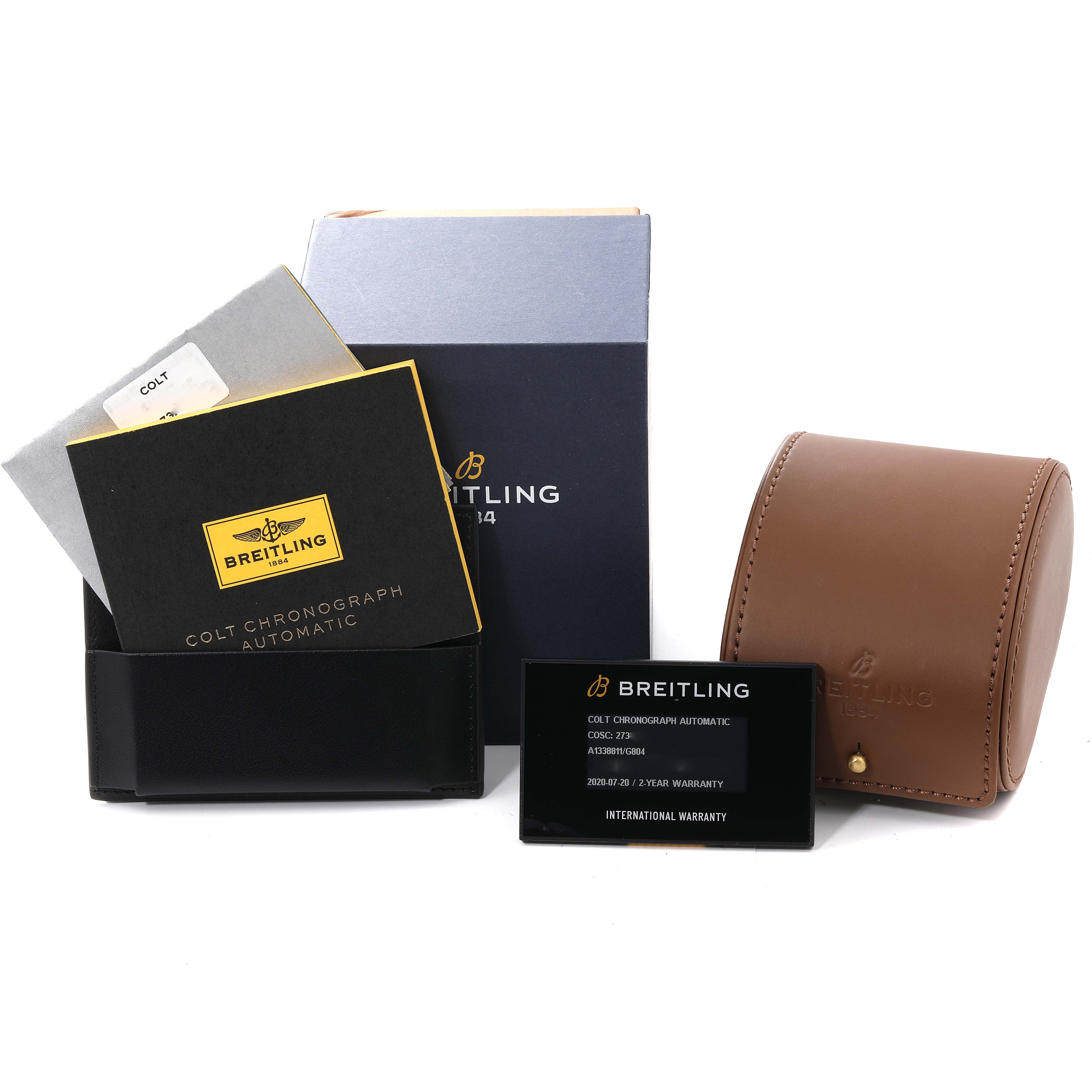 The image shows Breitling Colt A13388 Men's Stainless Steel White Dial A13388 Men's Stainless Steel White Dial model watch accessories including manuals, warranty card, and a brown leather carrying case.