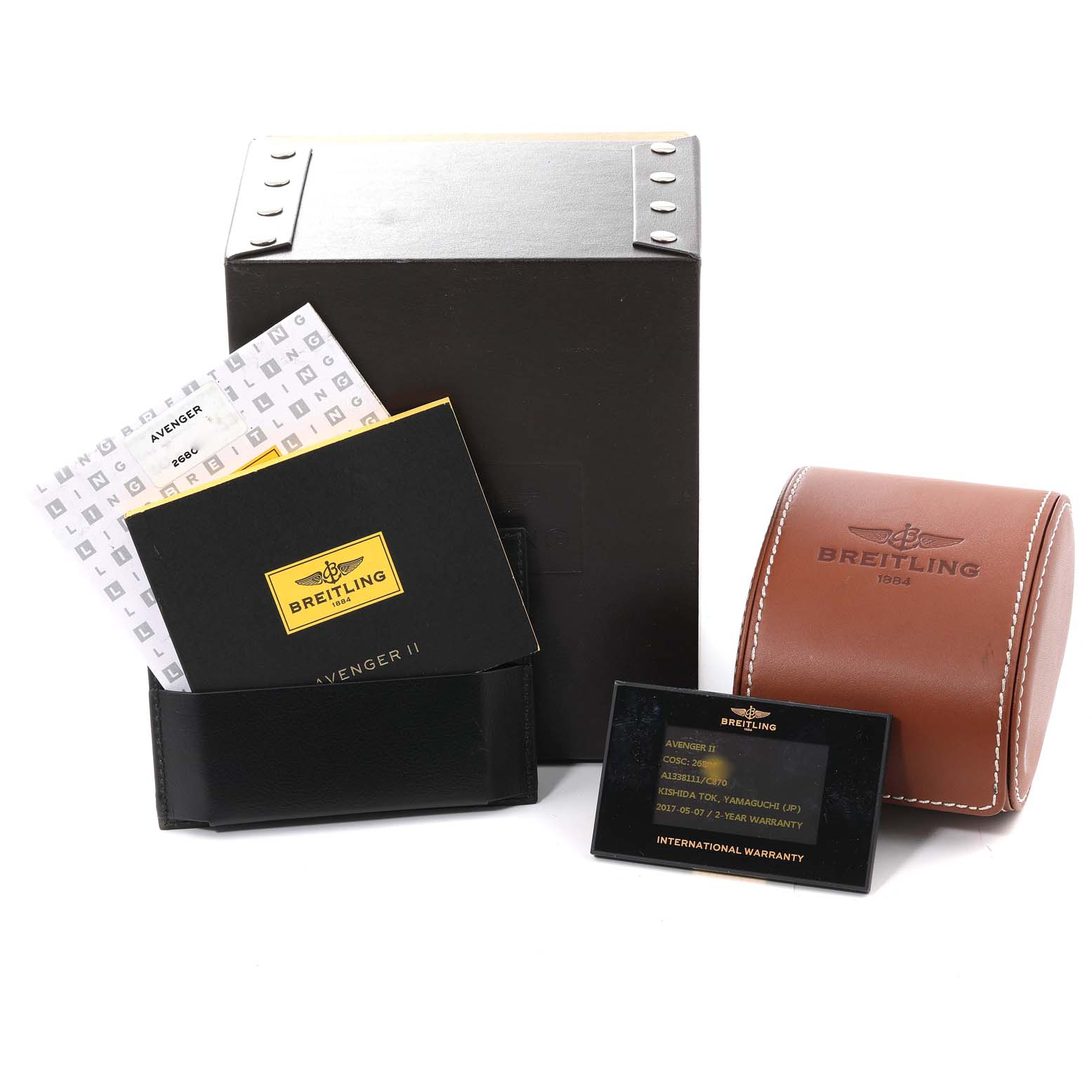 The image shows the accessories for a Breitling Avenger A13381 Men's Stainless Steel Blue Dial A13381 Men's Stainless Steel Blue Dial watch, including a box, leather pouch, manual, warranty card, and a brown case.