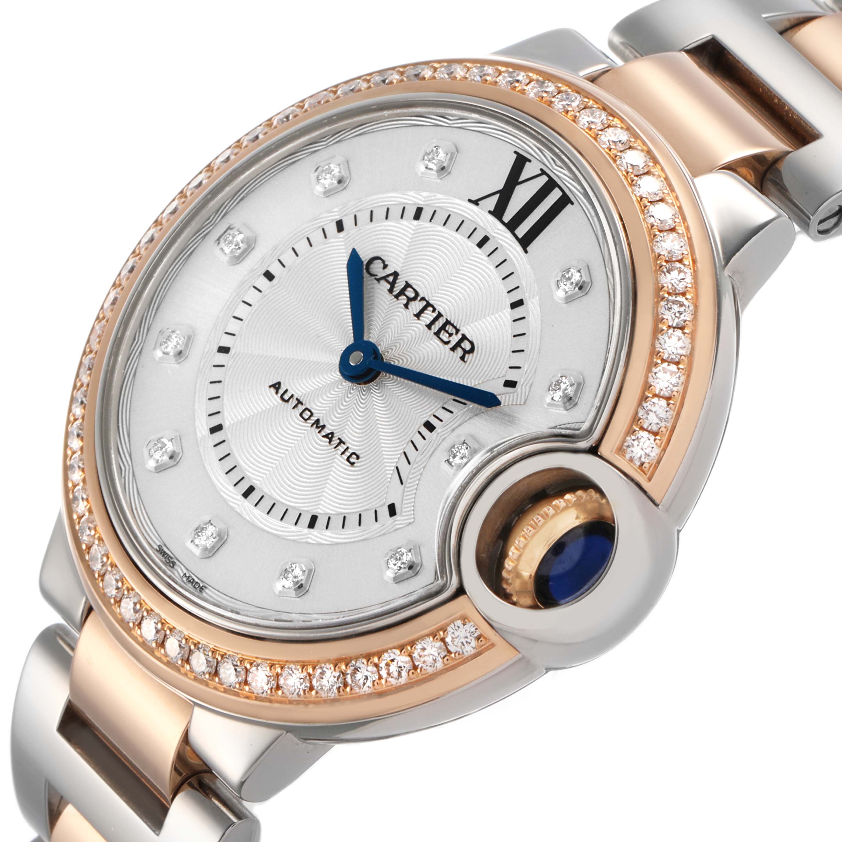 The Cartier Ballon Bleu WE902077 Women's Steel and Gold (two tone) Silver Dial watch is shown at a slight angle, highlighting the dial, bezel with diamonds, and part of the bracelet.