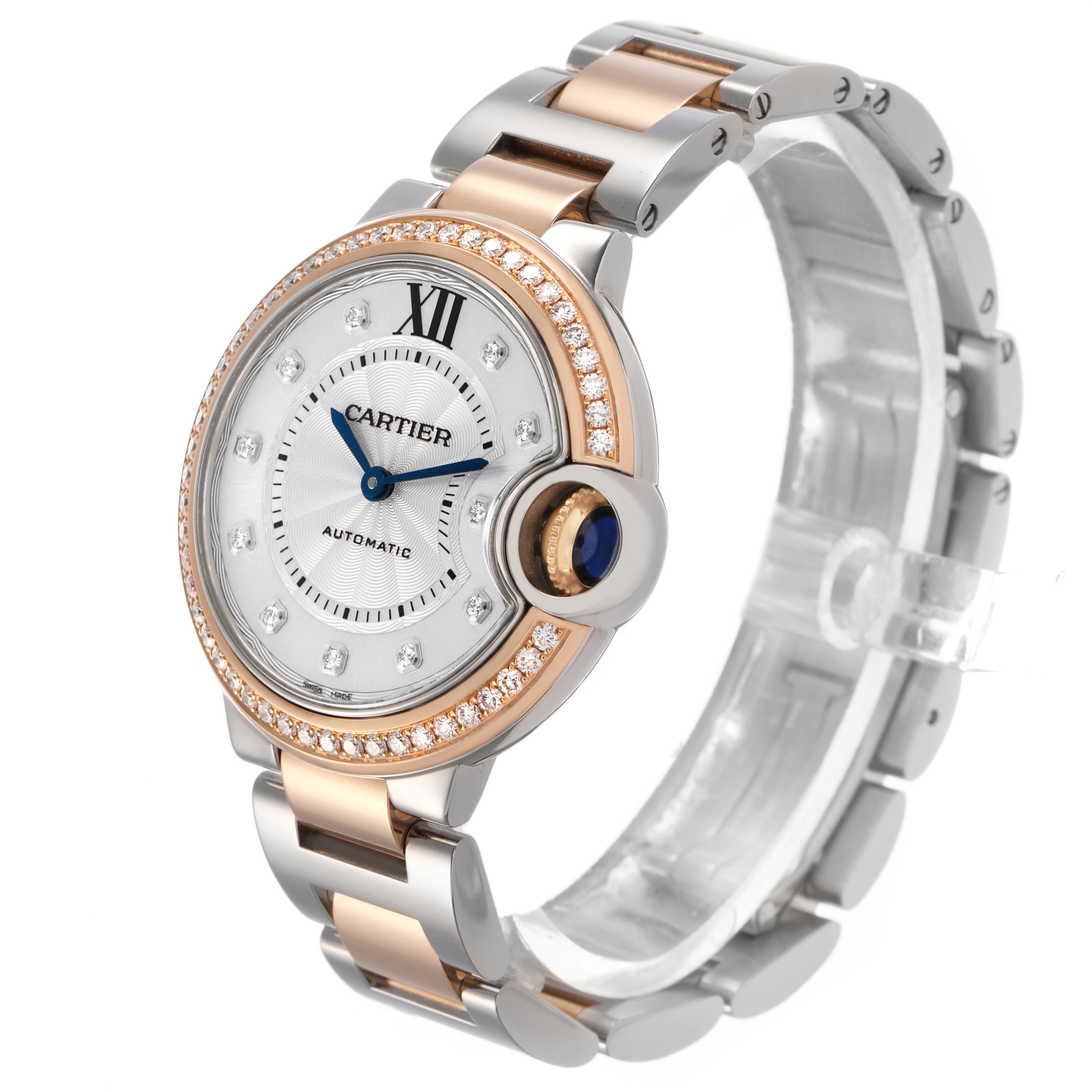 The Cartier Ballon Bleu WE902077 Women's Steel and Gold (two tone) Silver Dial watch is shown at a three-quarter angle, highlighting the face, bracelet, and crown with a blue cabochon.