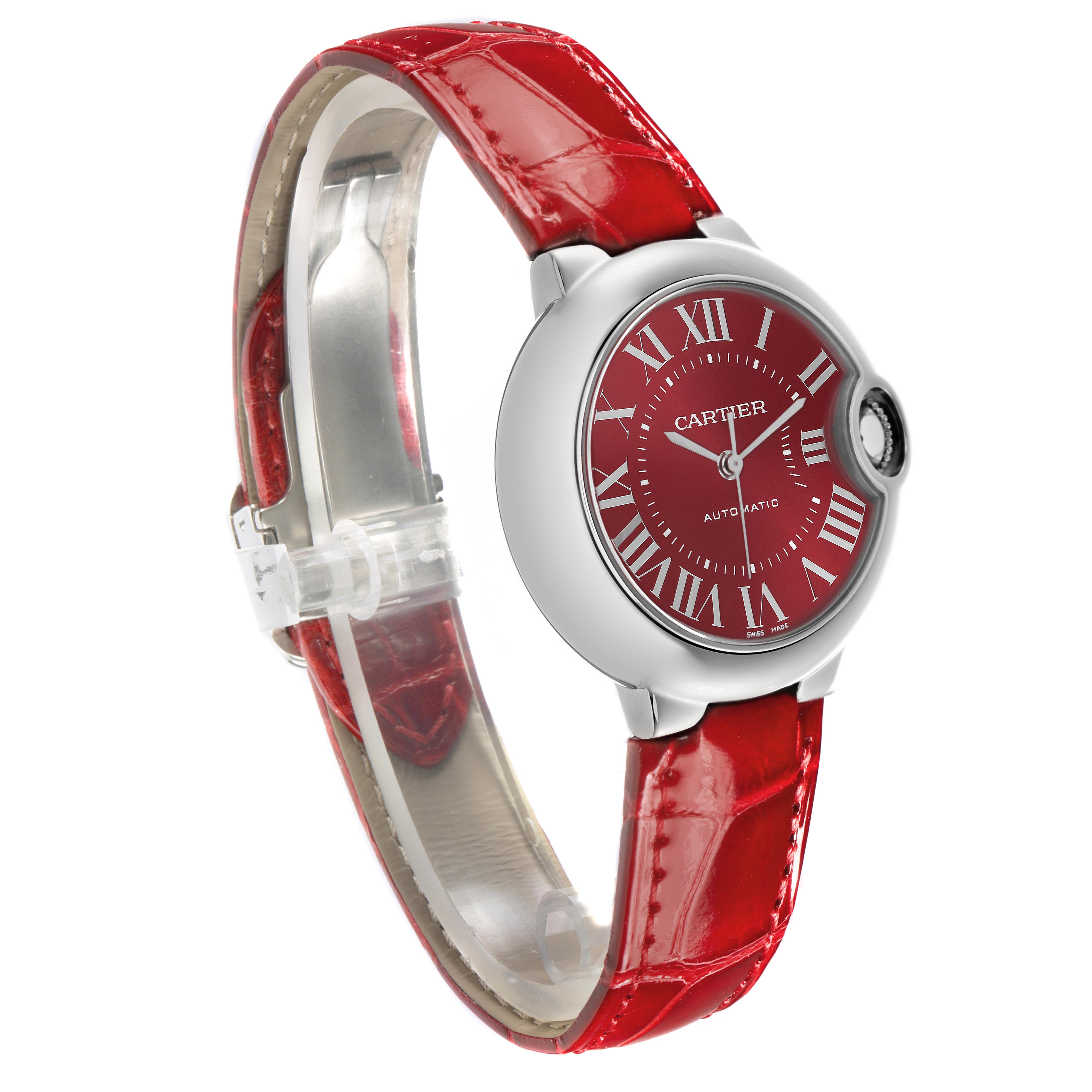 The Cartier Ballon Bleu WSBB0022 Women
s Stainless Steel Red Dial WSBB0022 Women
s Stainless Steel Red Dial watch is shown at a slight angle, displaying the dial, case, and red leather strap.