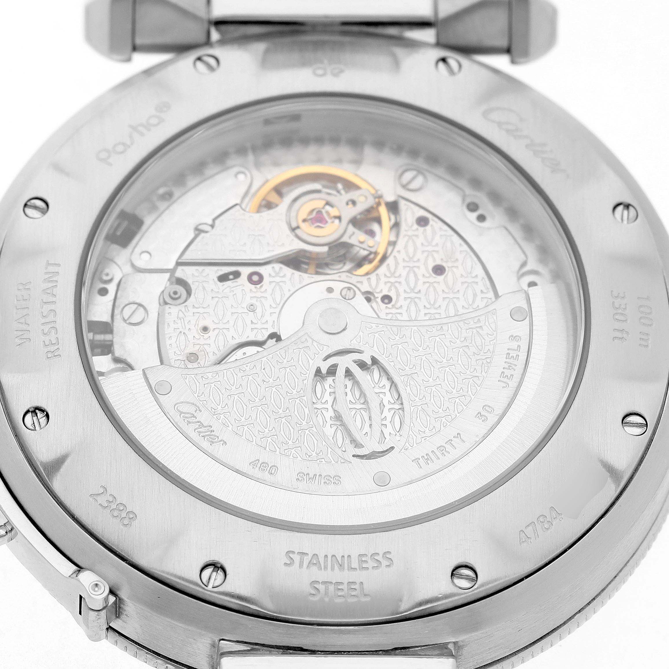 The image shows the back of a Cartier Pasha W31037H3 Men's Stainless Steel Silver Dial watch, highlighting the automatic movement and engravings on the stainless steel case.