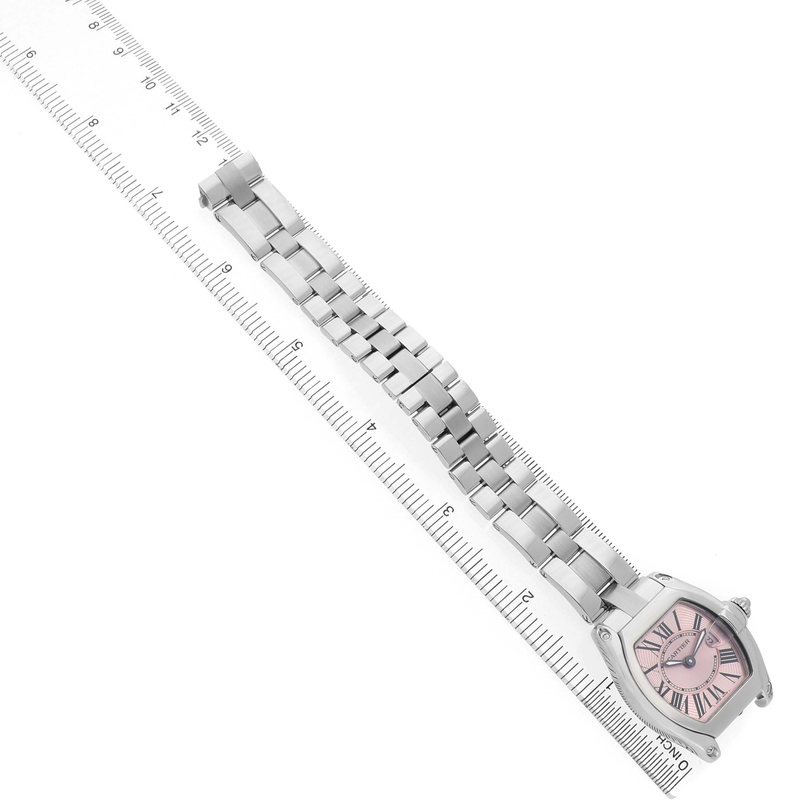 The Cartier Ballon Bleu W62017V3 Women's Stainless Steel Pink Dial watch is shown from an angled top view, displaying its face and entire bracelet laid alongside a ruler.