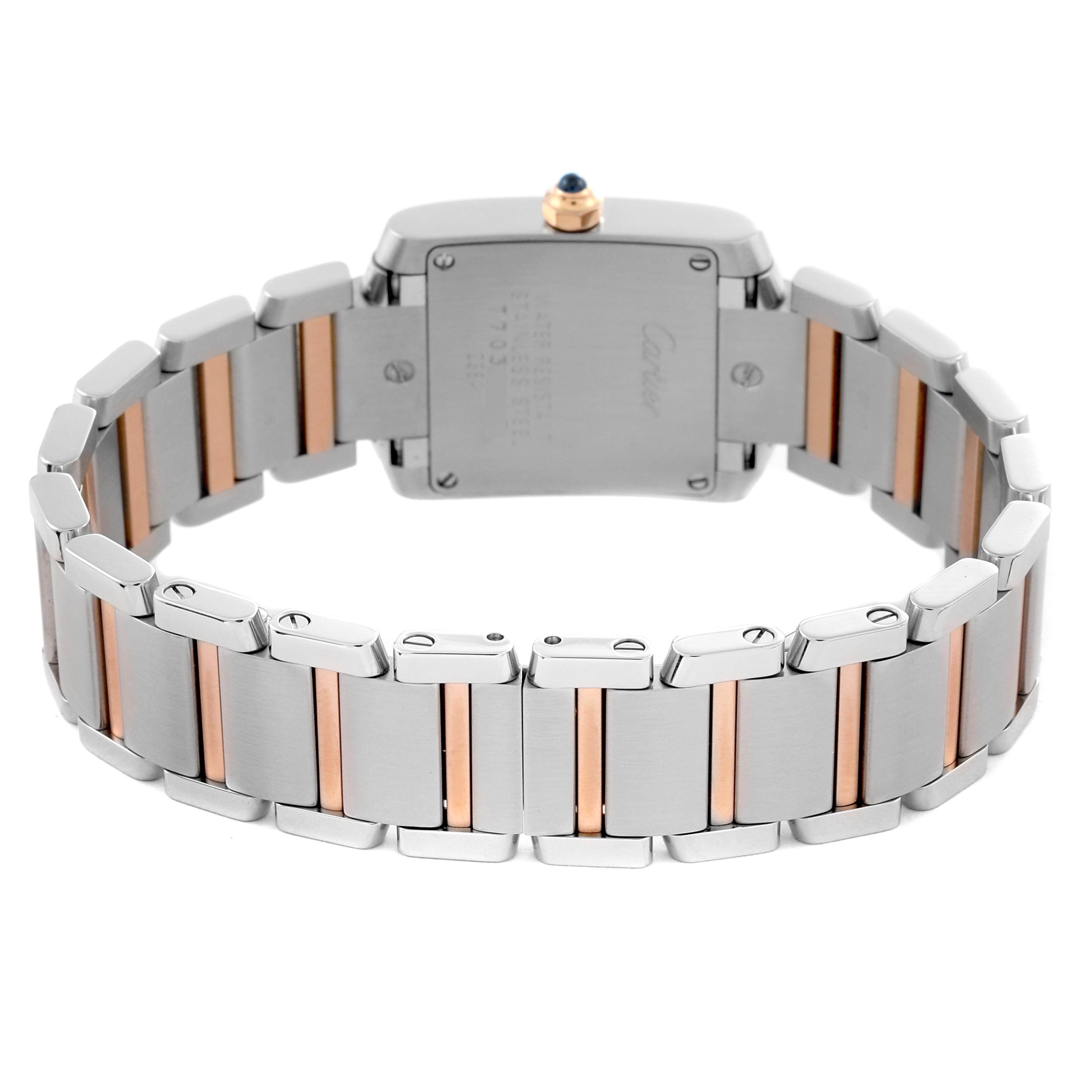 The Cartier Tank Française watch is shown from a rear angle, highlighting the case back and two-tone bracelet.