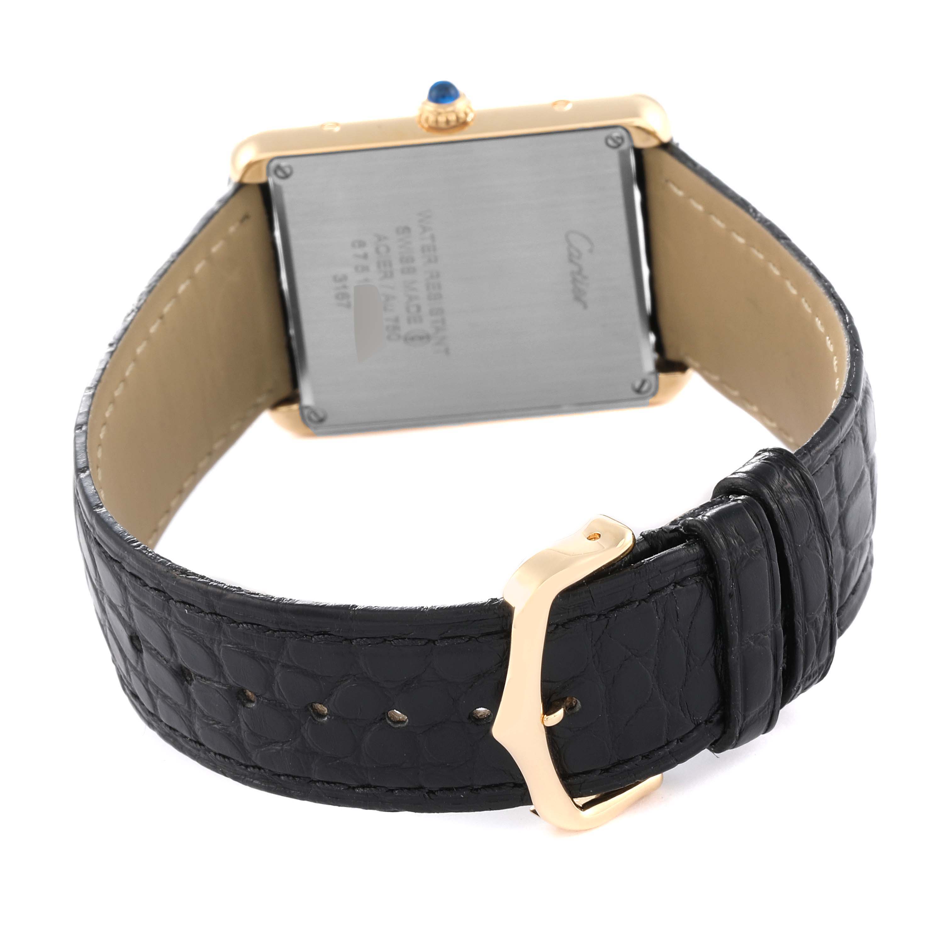 The image shows the back view of the Cartier Tank Solo W5200004 Men
s Yellow Gold Silver Dial W5200004 Men
s Yellow Gold Silver Dial watch, highlighting its case back, leather strap, and buckle.