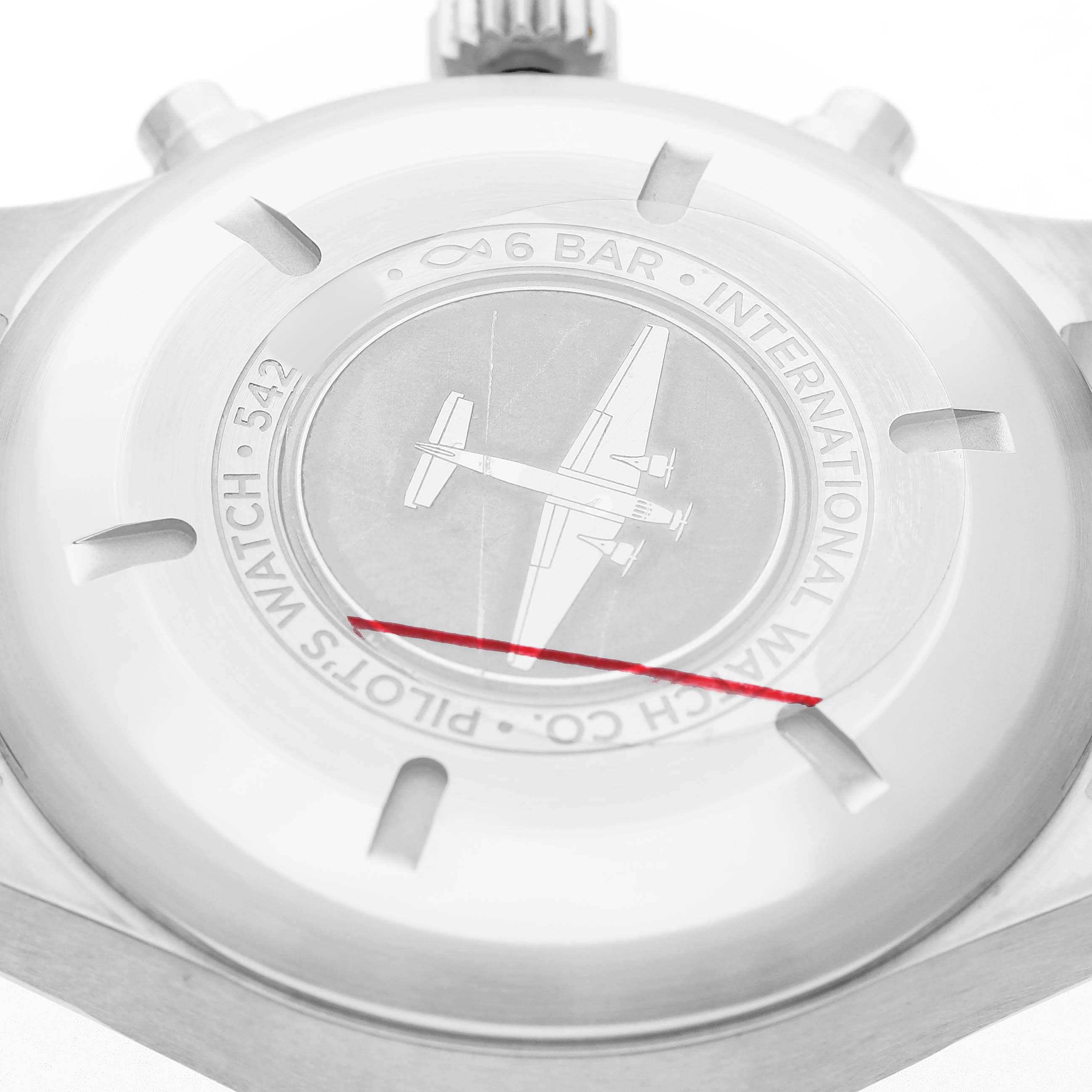 The image shows the case back of an IWC Pilot IW377710 Men's Stainless Steel Black Dial model watch, featuring an engraved airplane and brand markings.