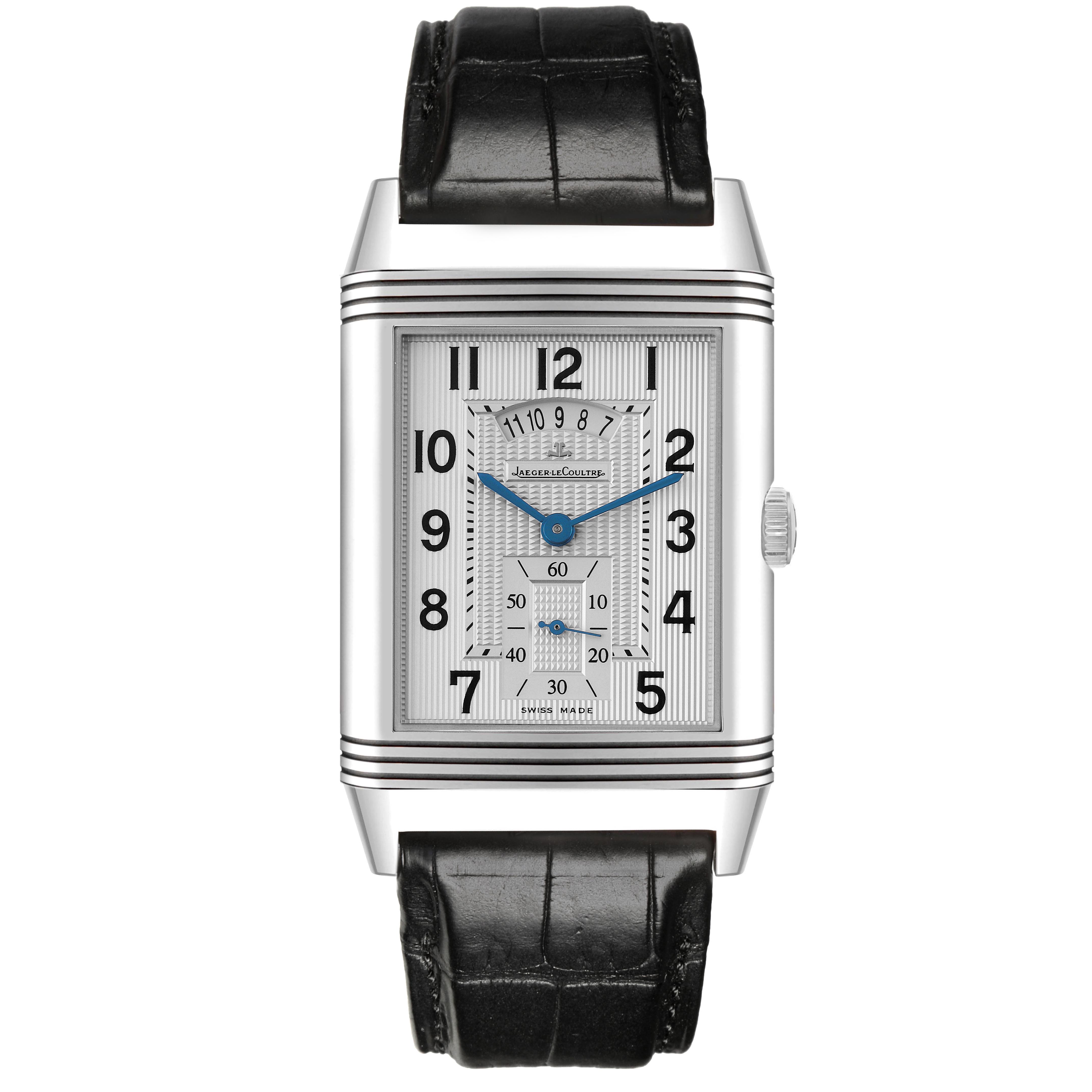 The Jaeger-LeCoultre Reverso watch is shown from the front, displaying its rectangular face, blue hands, and black leather strap.