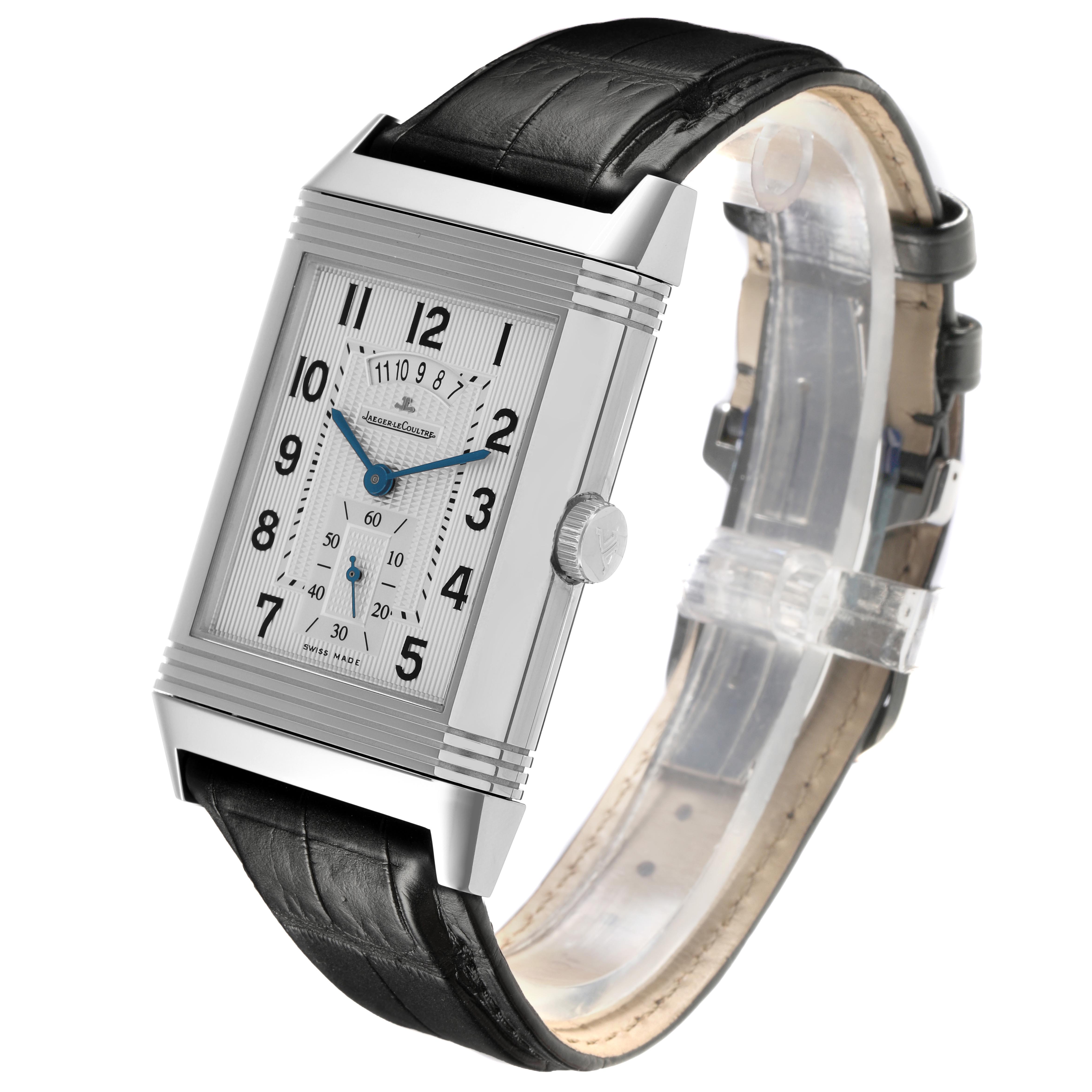 The Jaeger-LeCoultre Reverso watch is shown at a three-quarter angle, highlighting its rectangular face, leather strap, and crown.