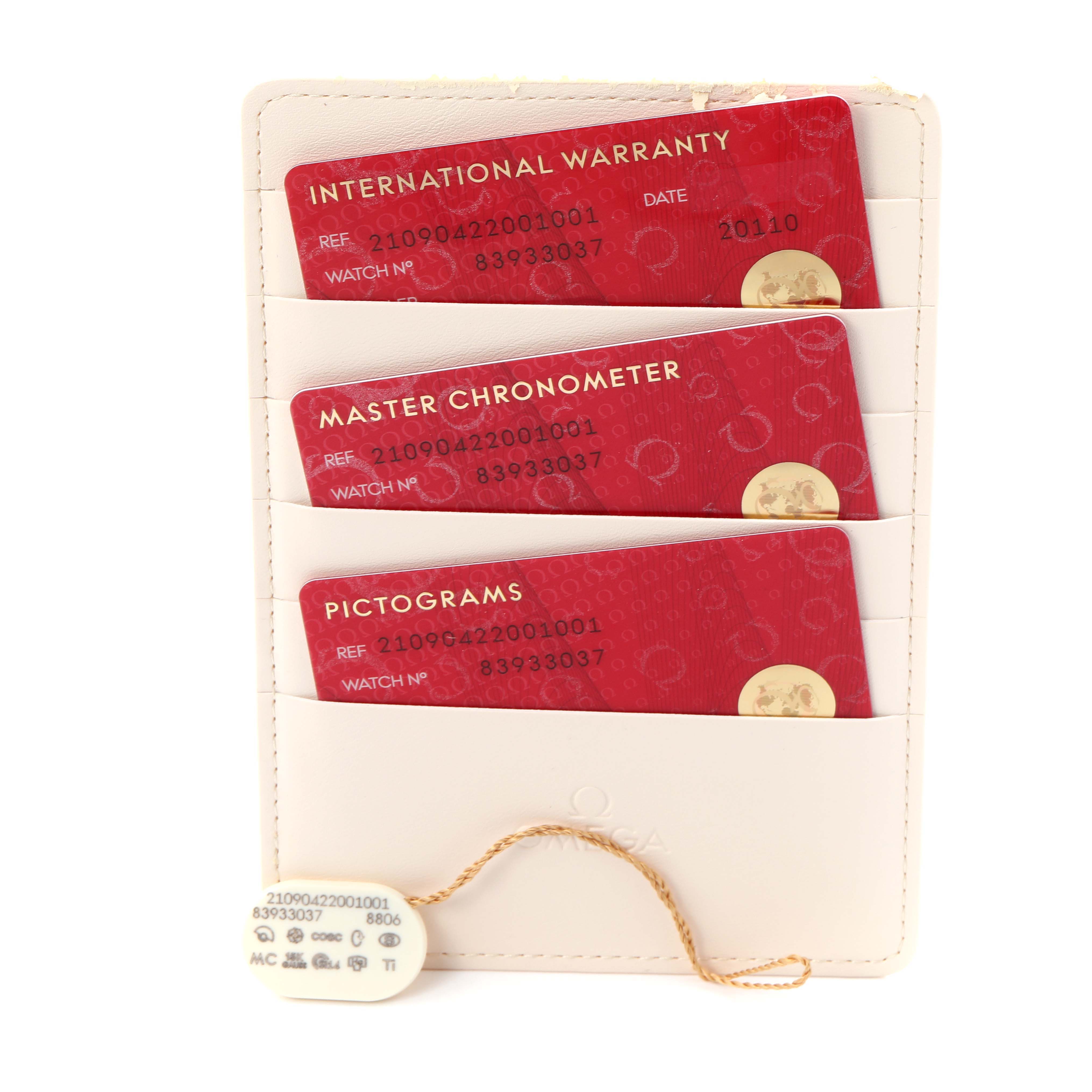 The image shows Omega Seamaster 210.90.42.20.01.001 Men
s Titanium Brown Dial 210.90.42.20.01.001 Men
s Titanium Brown Dial accessories, including warranty, chronometer, and pictogram cards with a tag.