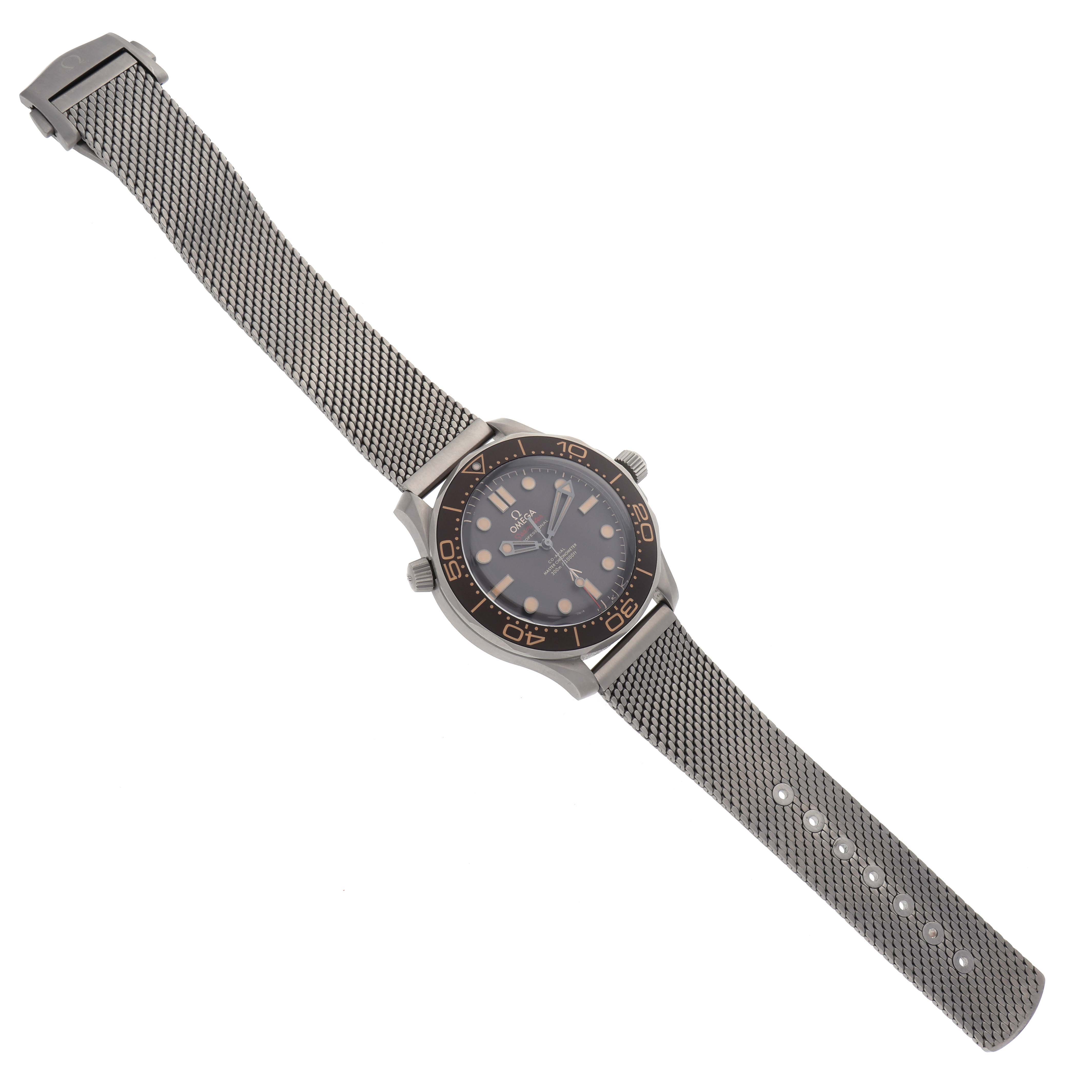 The Omega Seamaster 210.90.42.20.01.001 Men
s Titanium Brown Dial 210.90.42.20.01.001 Men
s Titanium Brown Dial watch is shown from a top-down angle, displaying its face, bezel, case, and metal mesh strap.