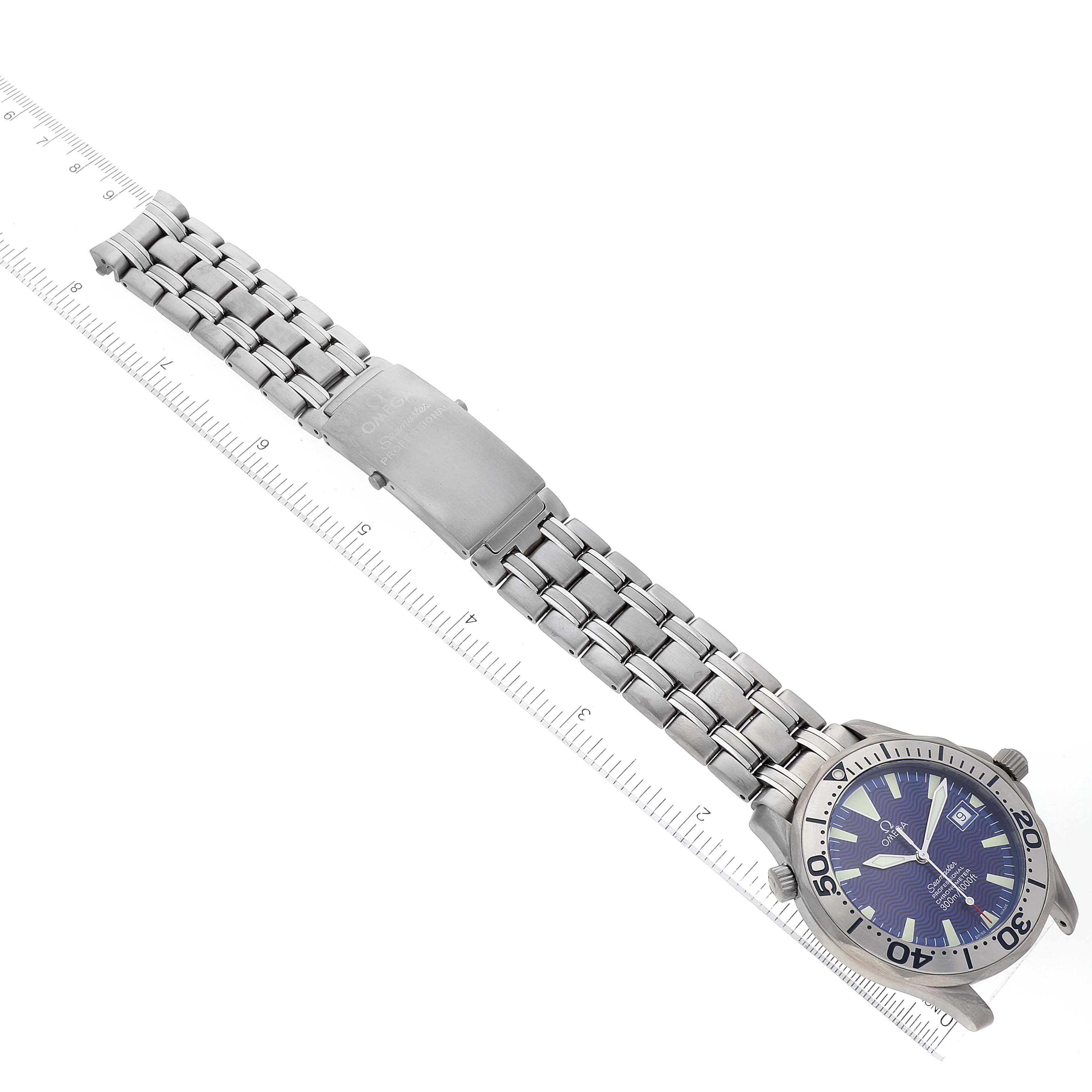 The image shows an Omega Seamaster 2231.80.00 Men's Titanium Blue Dial 2231.80.00 Men's Titanium Blue Dial watch lying flat, displaying its dial, bezel, and stainless steel bracelet with a measuring scale.