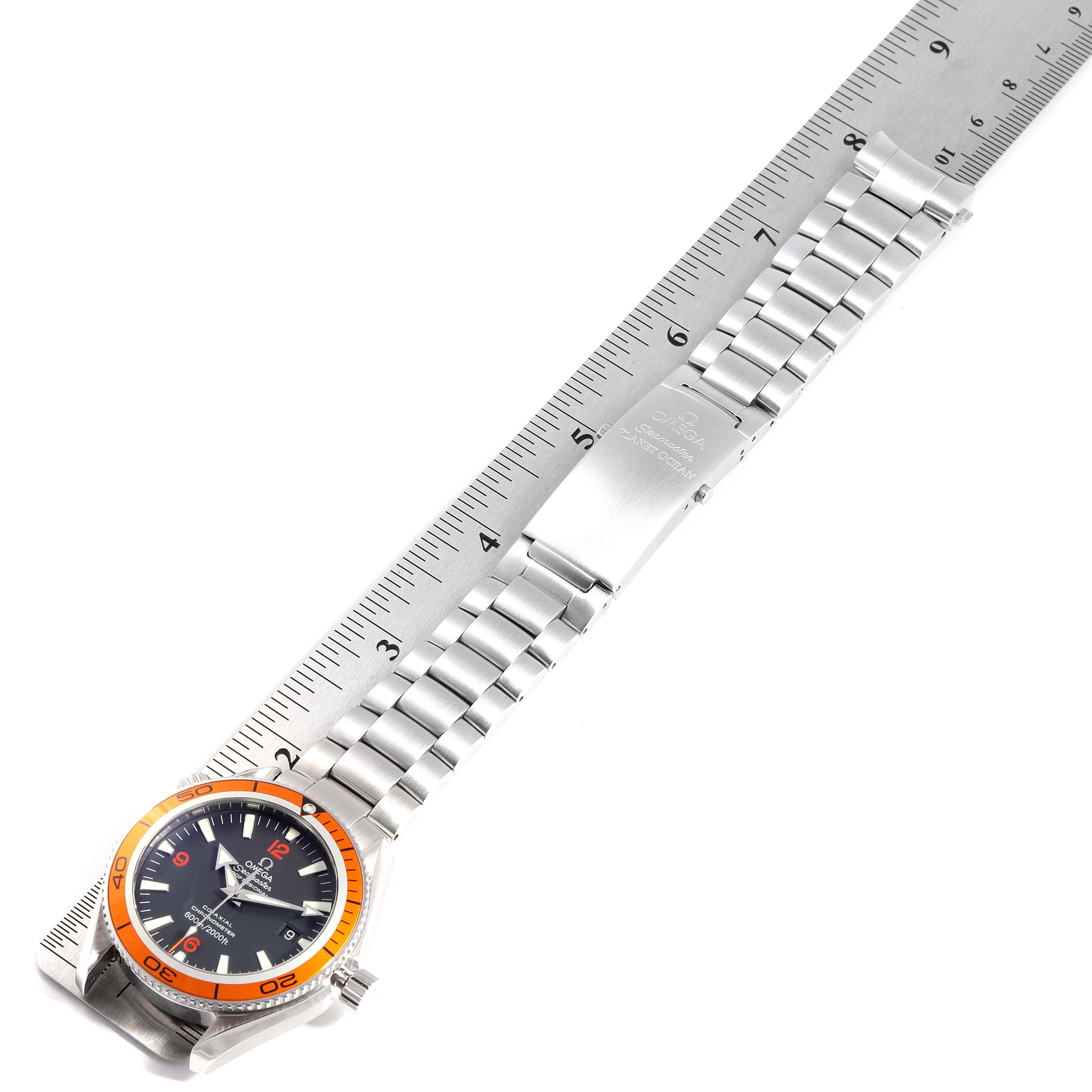 The Omega Planet Ocean 2209.50.00 Men
s Stainless Steel Black Dial 2209.50.00 Men
s Stainless Steel Black Dial watch is shown laid flat, showcasing its face, bezel, bracelet, and clasp alongside a ruler.