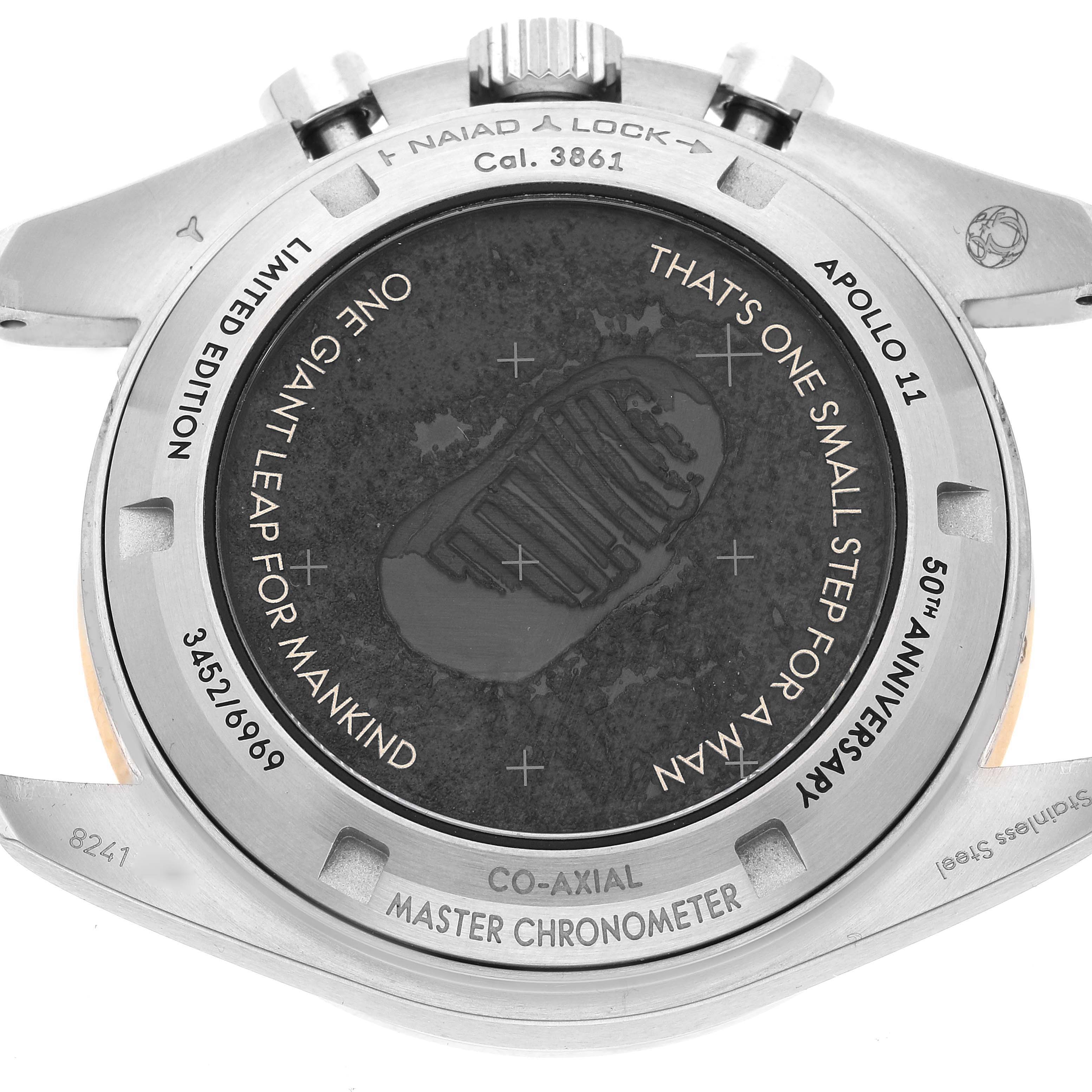 The image shows the case back of an Omega Speedmaster 310.20.42.50.01.001 Men's Stainless Steel Grey Dial 310.20.42.50.01.001 Men's Stainless Steel Grey Dial watch, adorned with commemorative engravings.