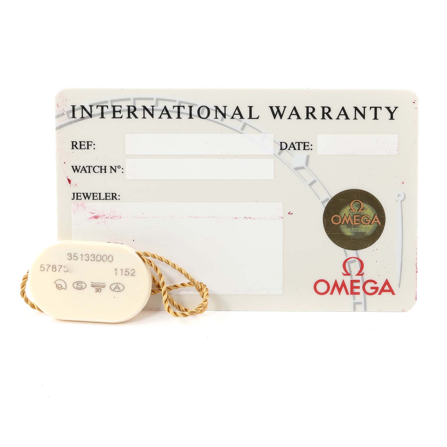 The image shows an Omega Speedmaster 3513.30.00 Men's Stainless Steel Silver Dial 3513.30.00 Men's Stainless Steel Silver Dial international warranty card and a white tag with a serial number.