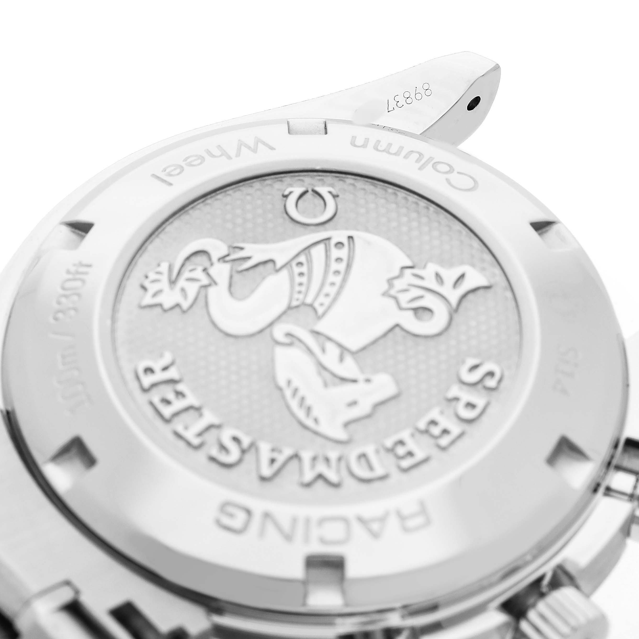 The image shows the engraved case back of an Omega Speedmaster 326.30.40.50.11.001 Men's Stainless Steel Red Dial, viewed at a tilted angle.