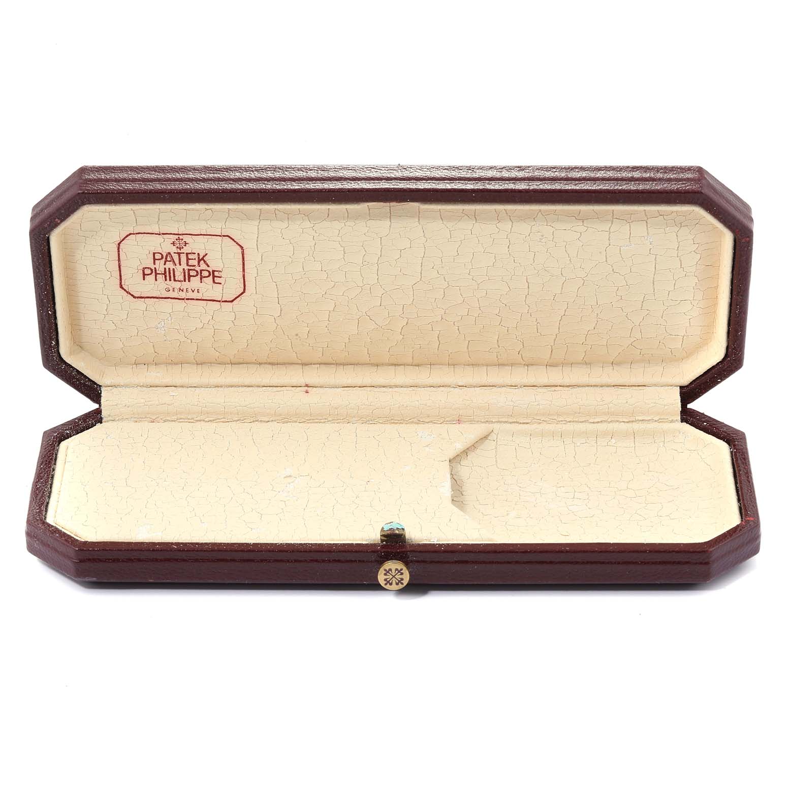 An open, vintage Patek Philippe watch case with a beige interior and a brown exterior is displayed.