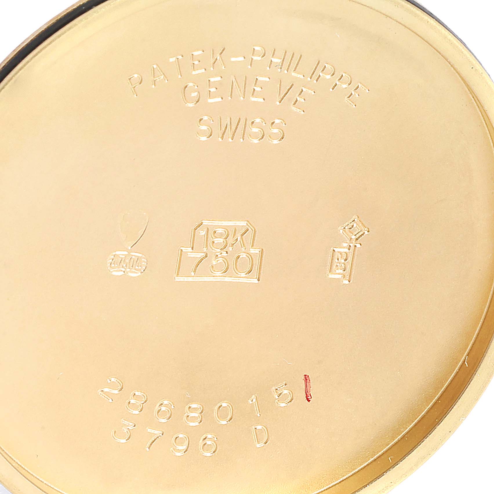 This image shows the engraved details inside the case back of a Vintage Patek Philippe watch, indicating its gold content and serial numbers.