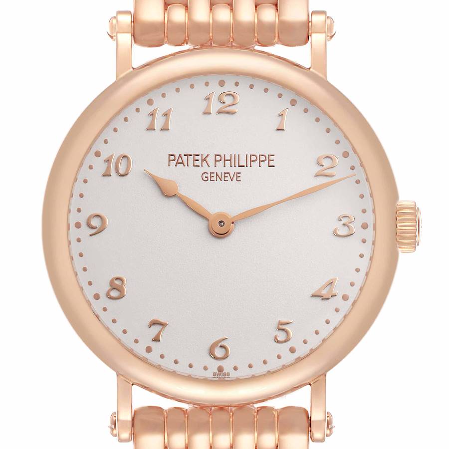 The Patek Philippe Calatrava watch is shown from a front angle, highlighting its round dial, hour markers, and bracelet.