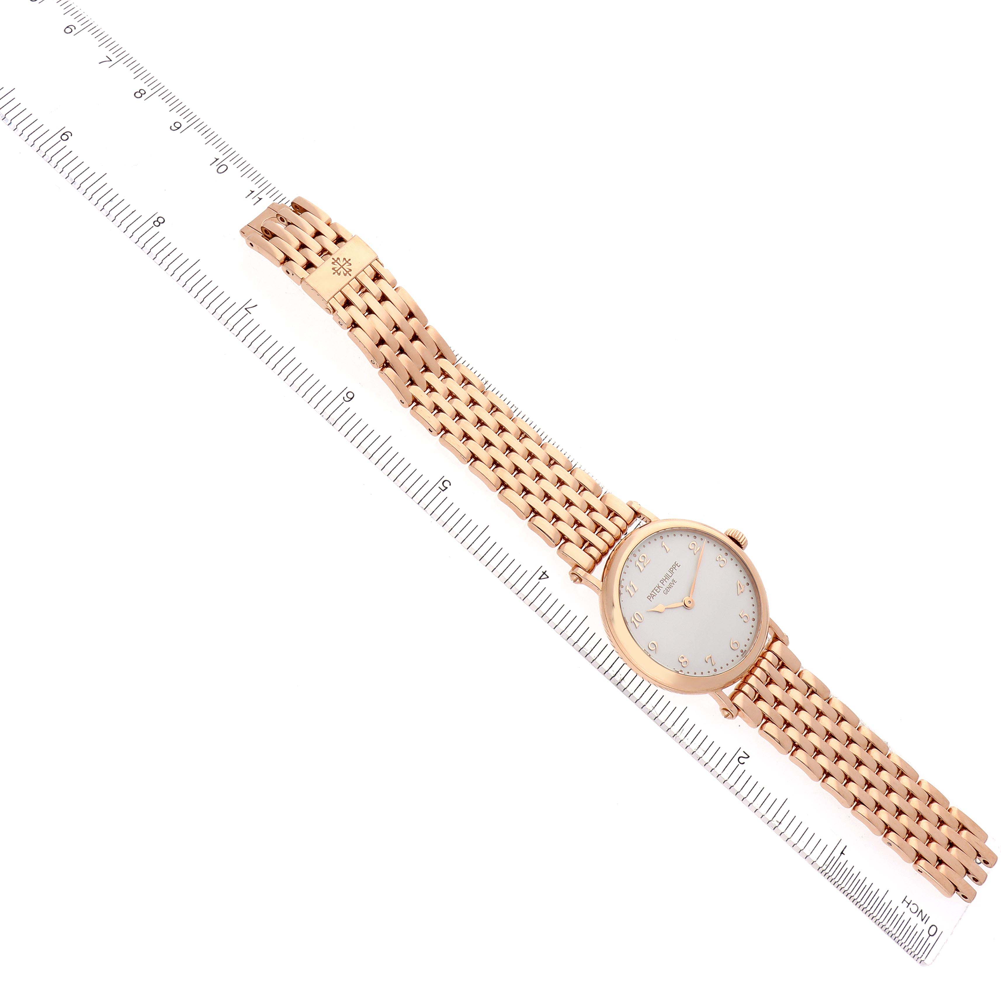 The Patek Philippe Calatrava 7200/1R-001 Men
s Rose Gold Silver Dial 7200/1R-001 Men
s Rose Gold Silver Dial watch is displayed diagonally, showing the face, crown, and full bracelet, with a ruler for scale.