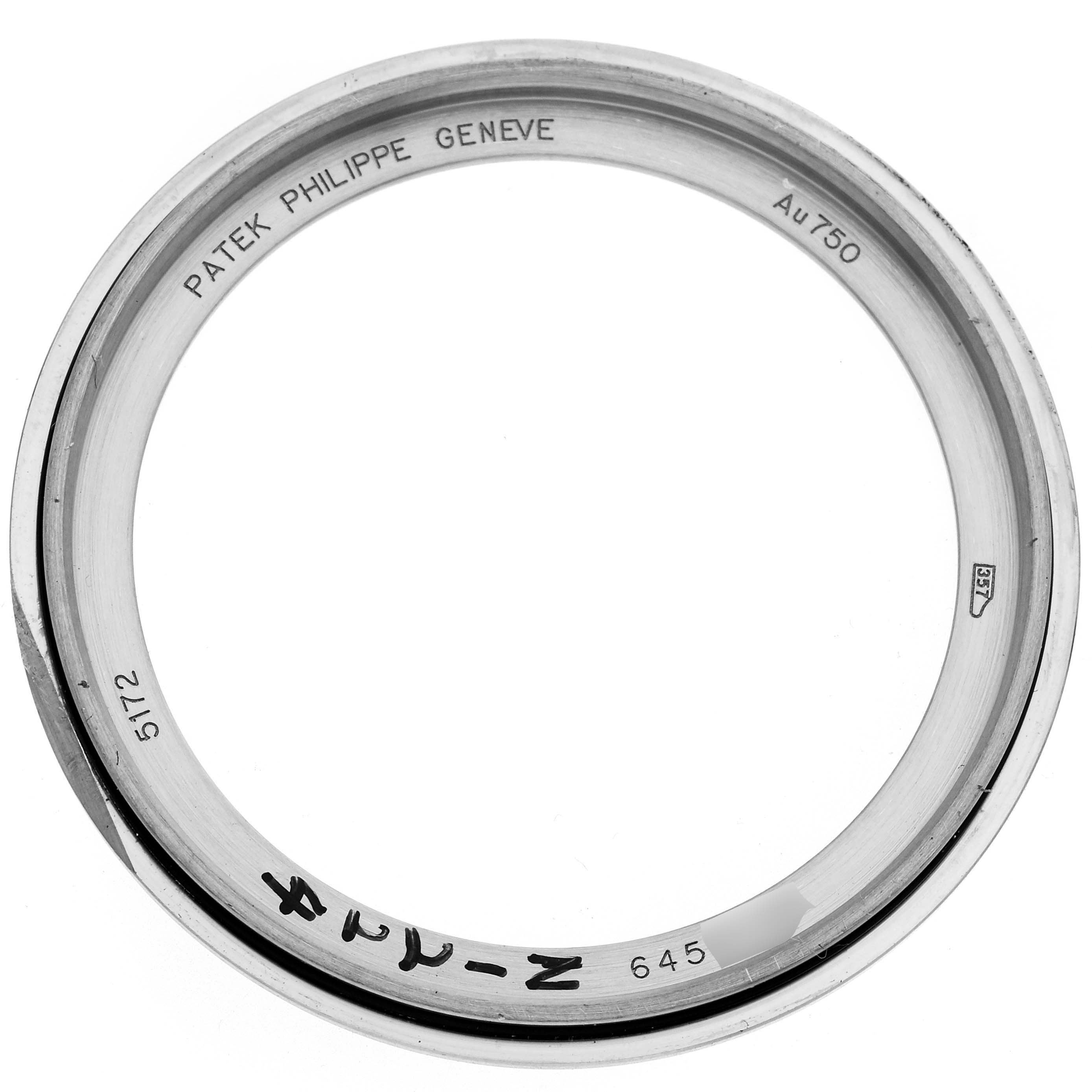 The image shows the bezel of a Patek Philippe Complications 5172G-001 Men
s White Gold Blue Dial 5172G-001 Men
s White Gold Blue Dial watch, viewed from the top, displaying inscriptions and markings.