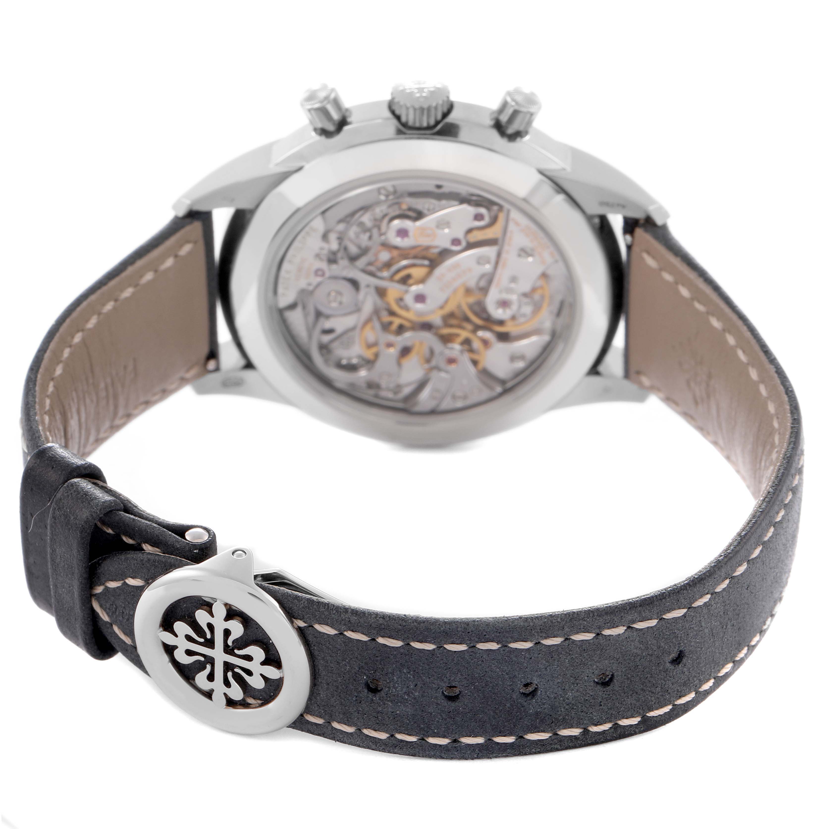 The Patek Philippe Complications 5172G-001 Men
s White Gold Blue Dial 5172G-001 Men
s White Gold Blue Dial watch is viewed from the back, showing the movement and leather strap with a clasp.